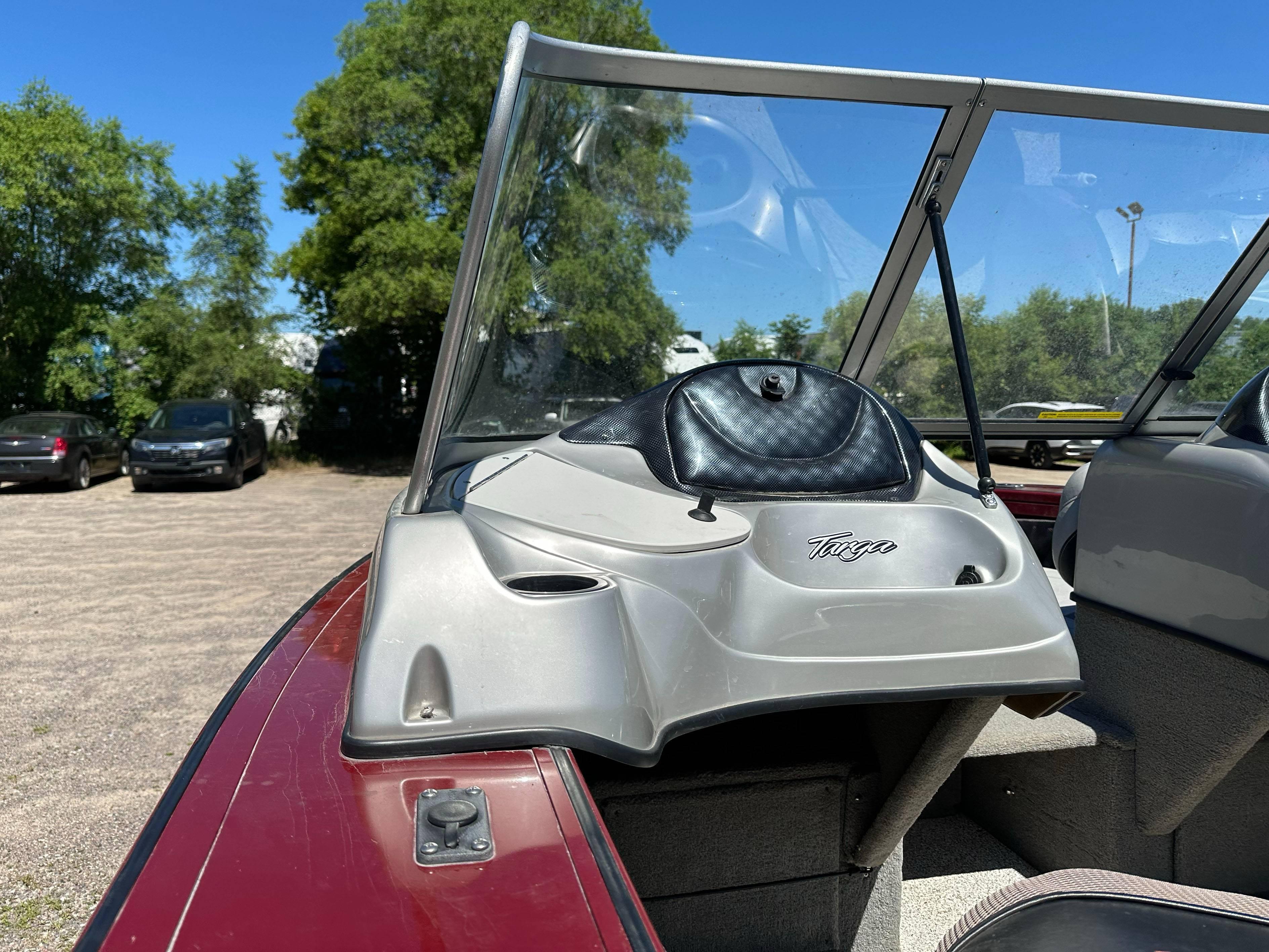2011 Tracker Targa V-18 Combo boat with windshield, parked outdoors on a sunny day.