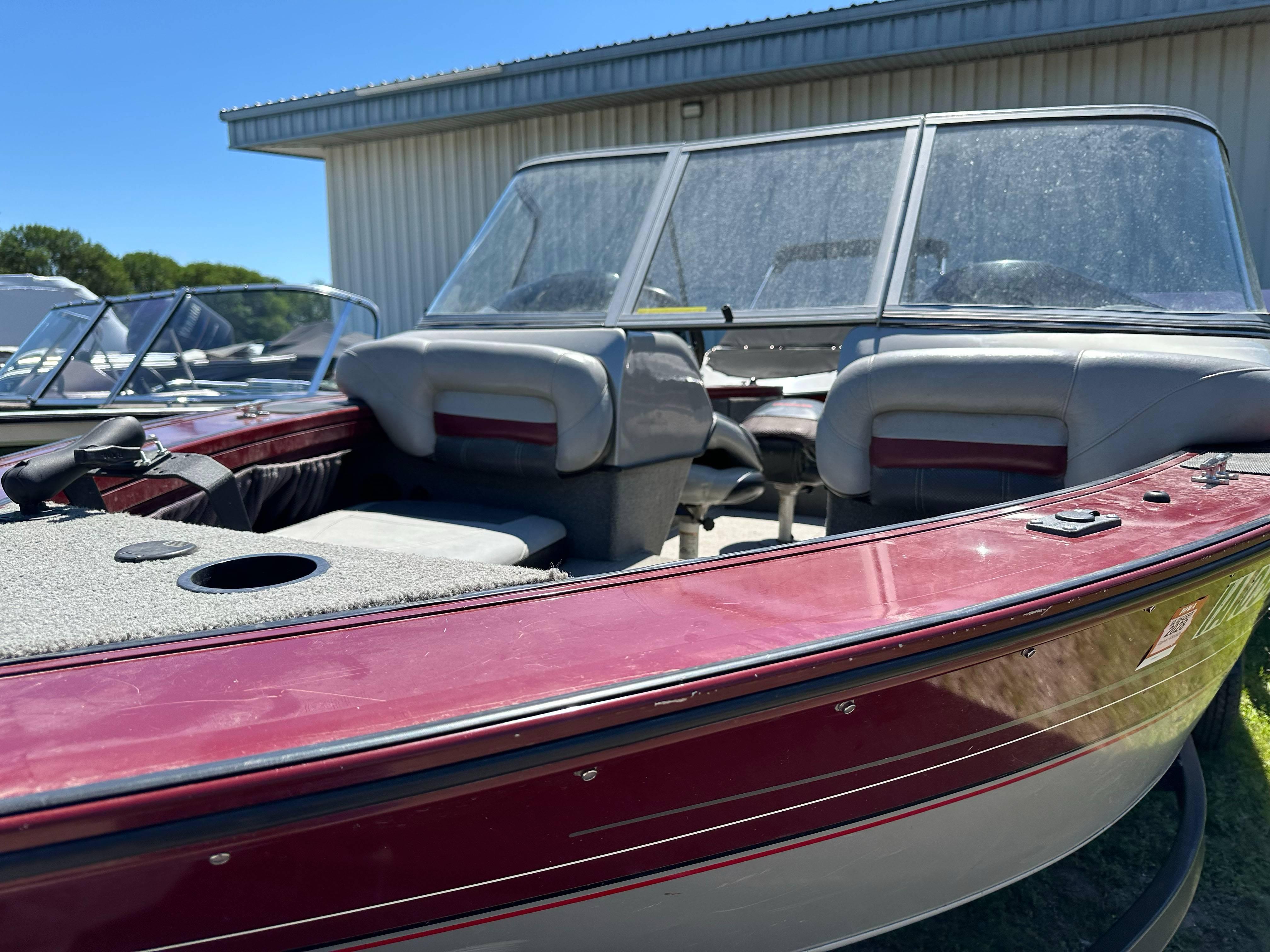 2011 Tracker Targa V-18 Combo boat with maroon exterior and spacious seating.