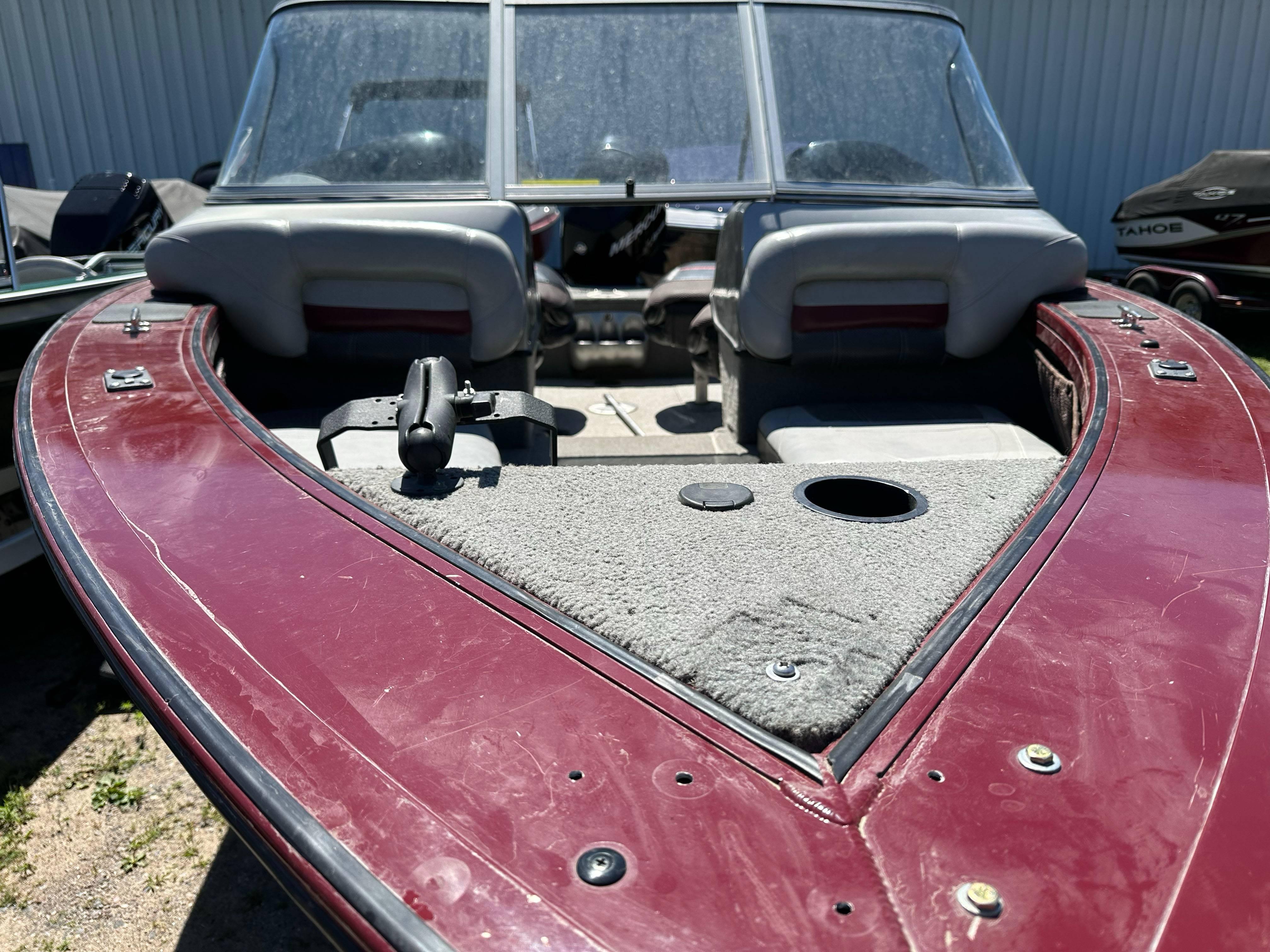 2011 Tracker Targa V-18 Combo boat with maroon deck and seating.