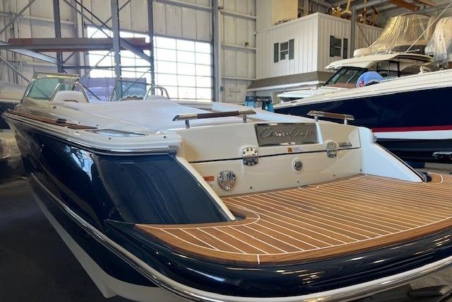 2021 Chris-Craft Launch 27 boat with elegant wood deck in a marina setting.