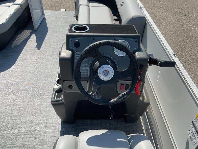 2026 Sun Tracker PB 16 DLX boat steering console with cup holder and seating.