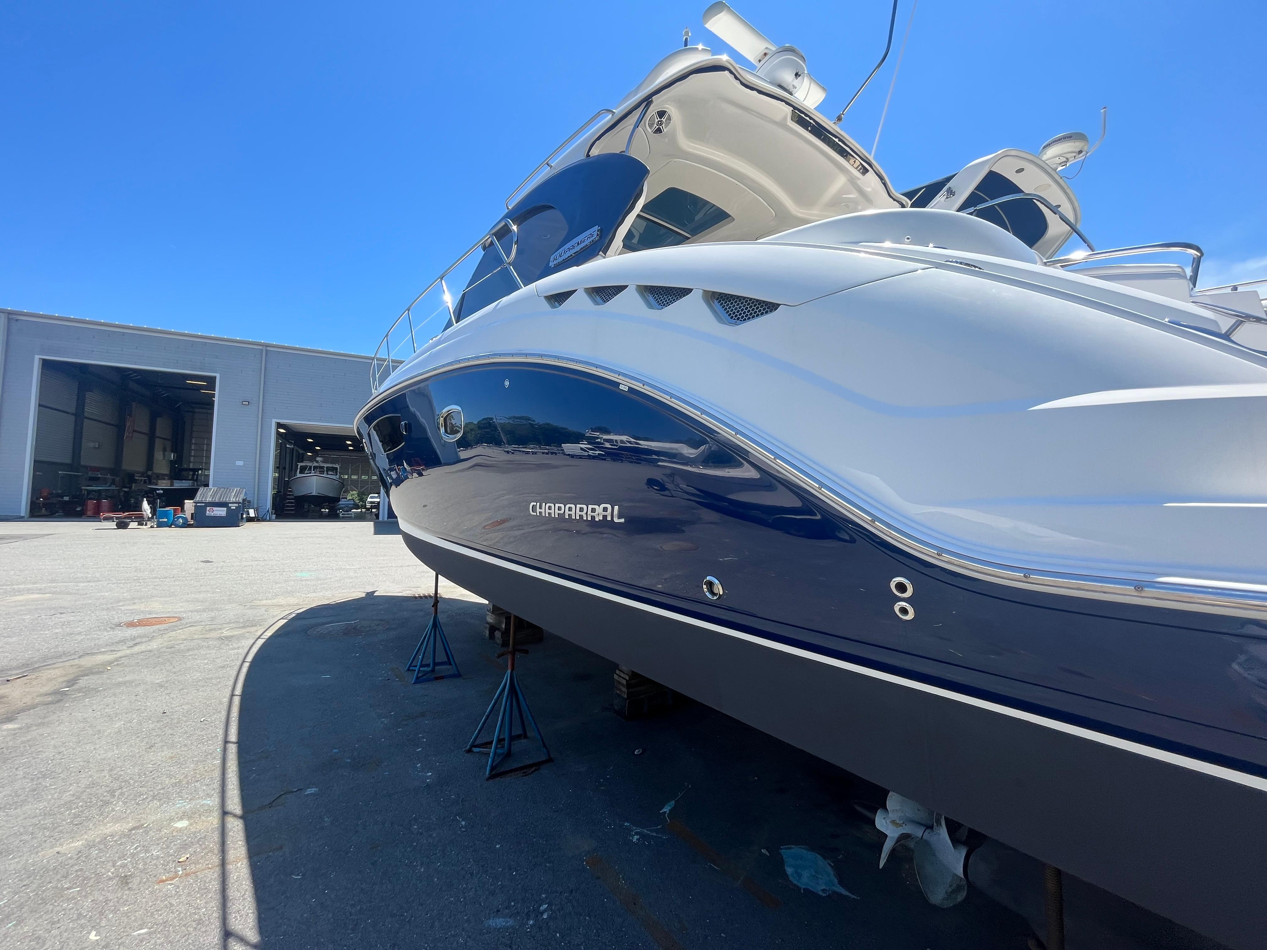 Chaparral-400 Premiere 2010-AURORA MA-US-2010 Chaparral 400 Premiere yacht on stands, outside a large warehouse, under clear blue sky.-9799863 | Thumbnail