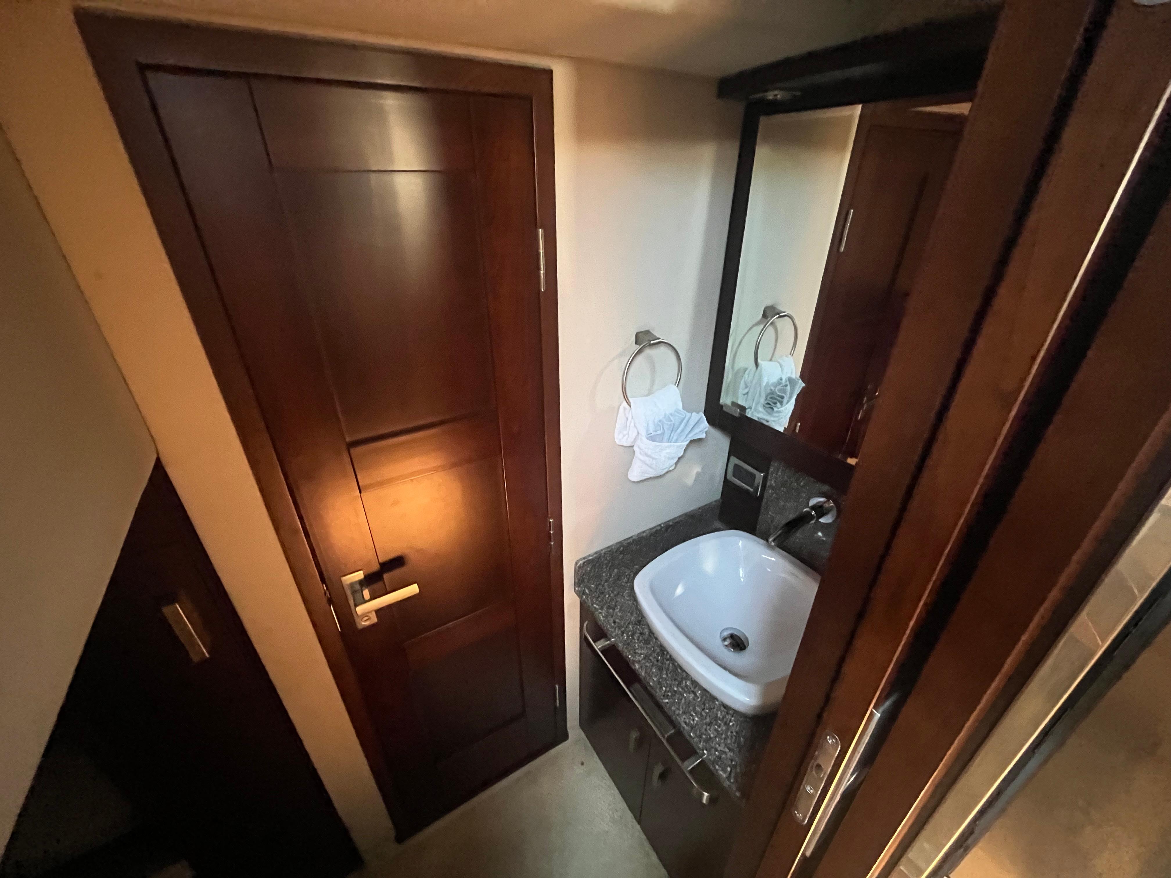 Chaparral-400 Premiere 2010-AURORA MA-US-Chaparral 400 Premiere 2010 yacht bathroom with wooden door, sink, and mirror.-9799863 | Thumbnail