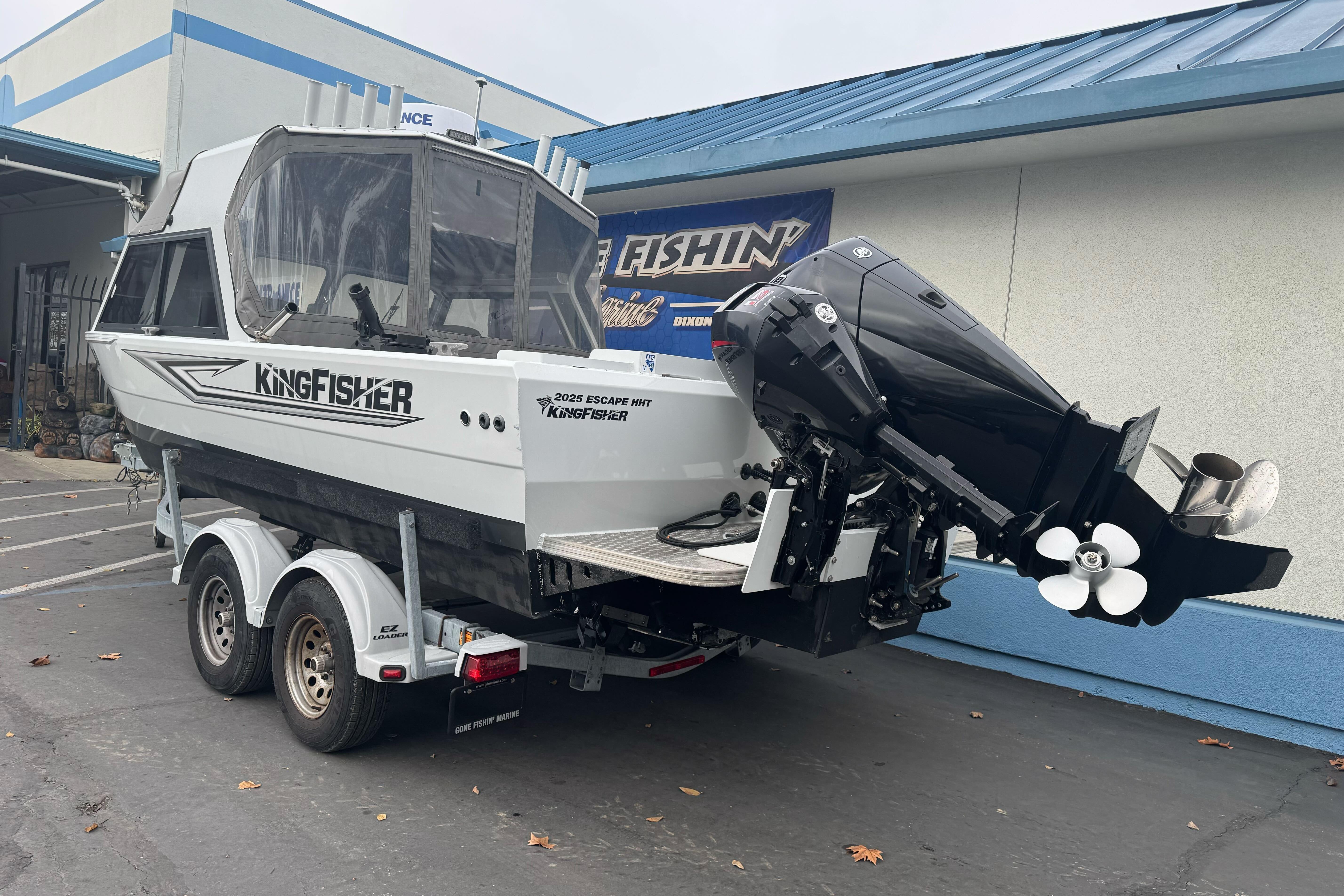 KingFisher 2025 Escape HHT boat, 2021 model, on trailer outside a building.
