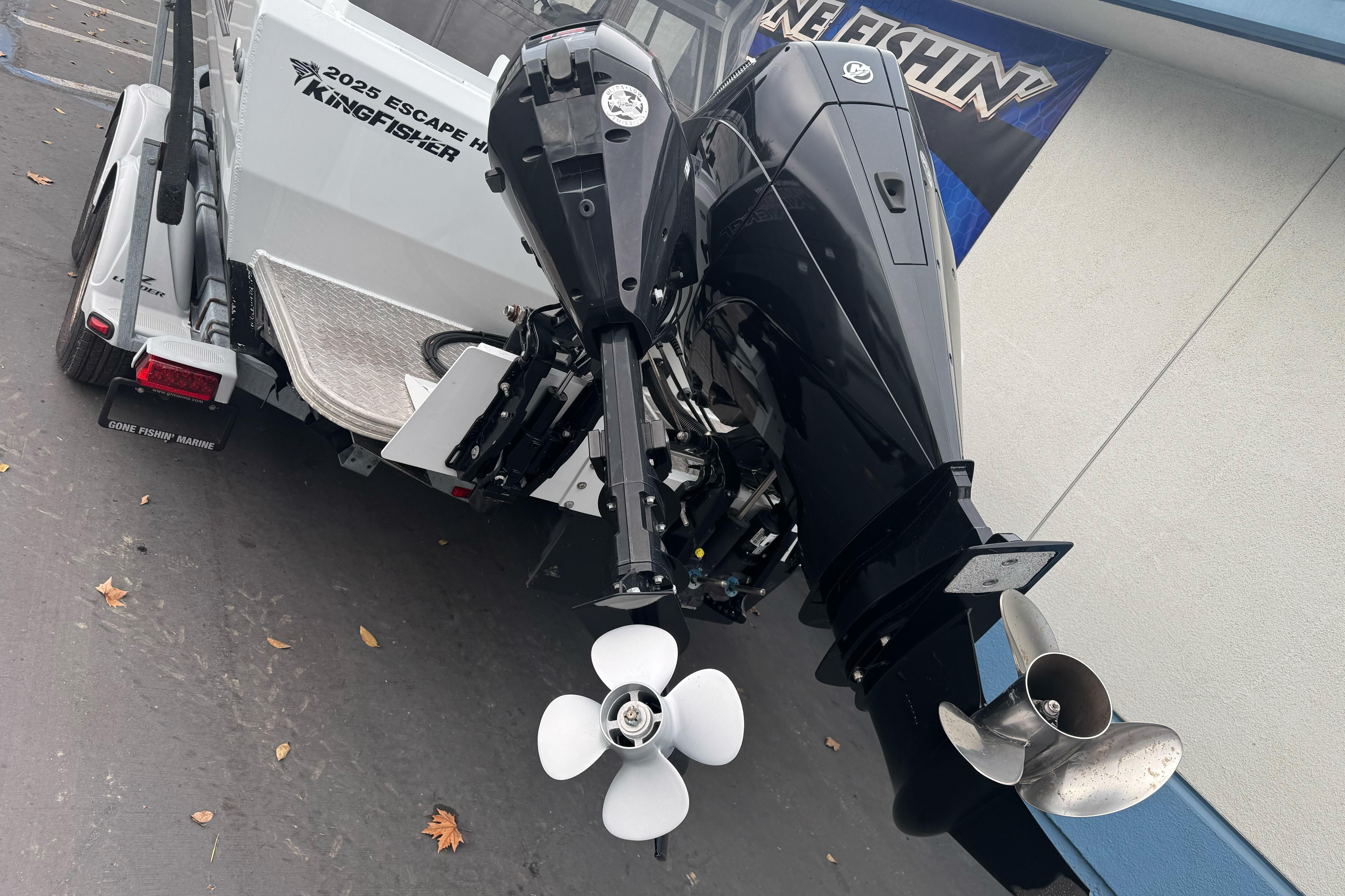 KingFisher 2025 Escape HHT boat with powerful outboard motor, rear view.