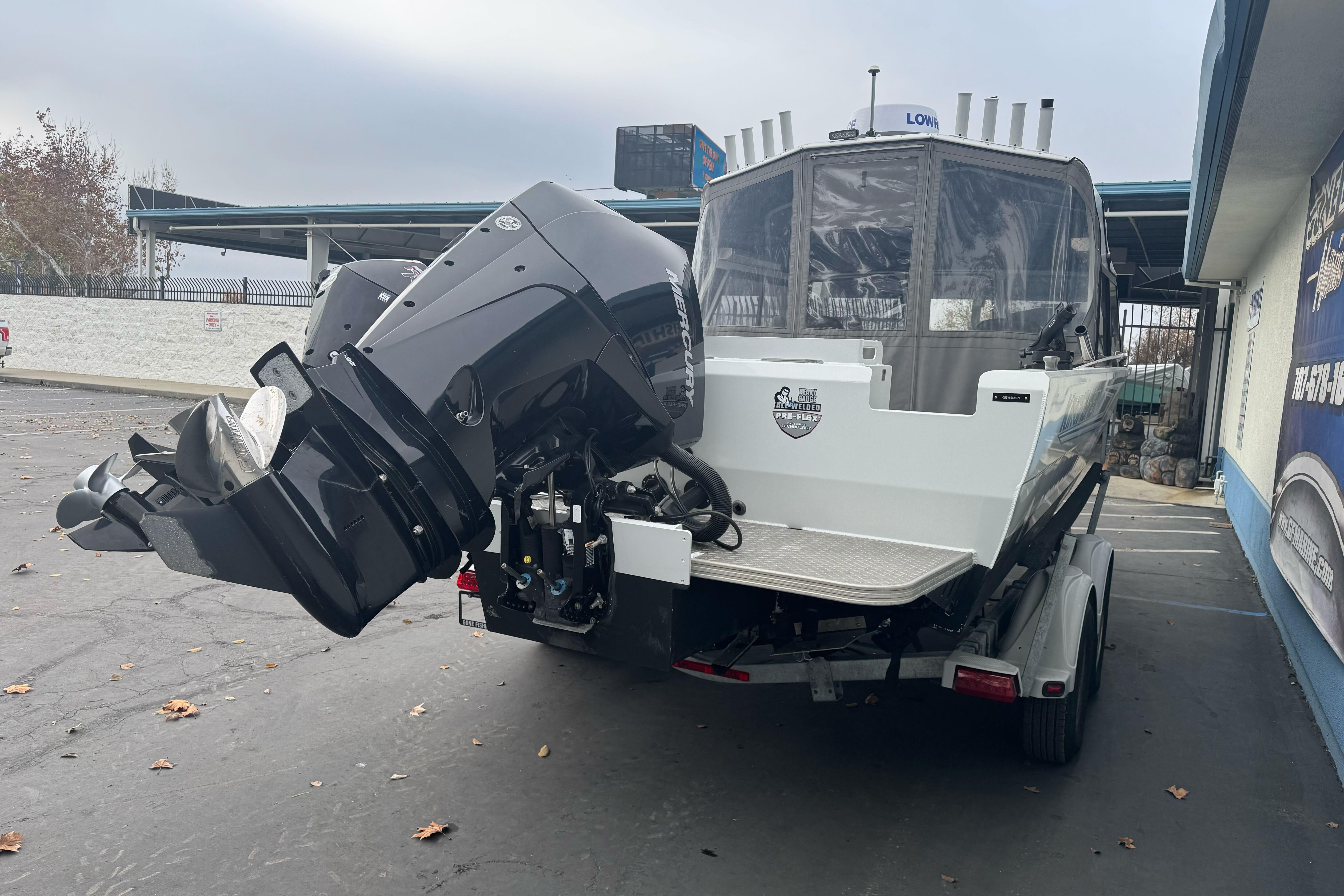 KingFisher 2025 Escape HHT boat, 2021 model, with powerful outboard motor on trailer.