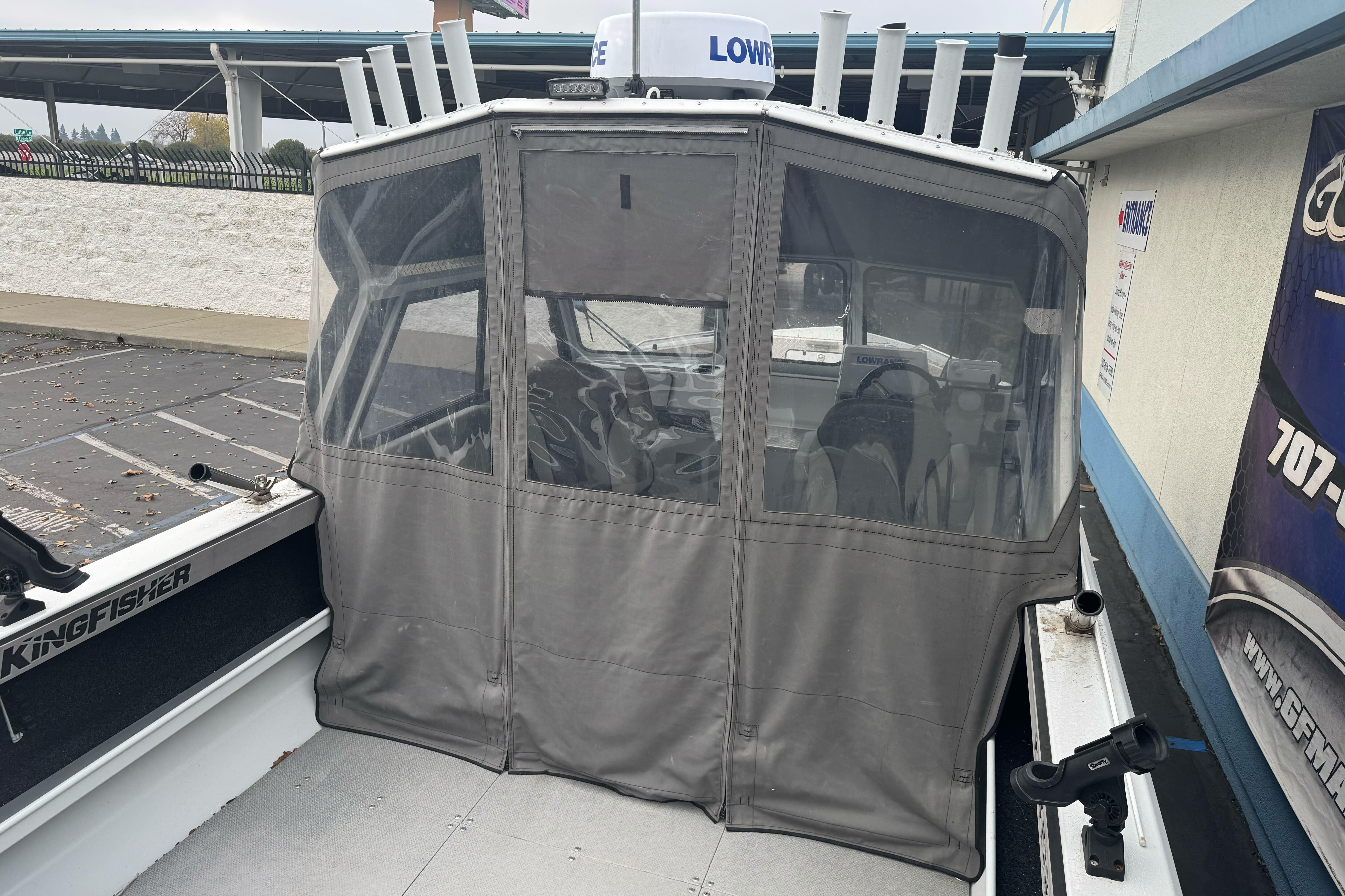 KingFisher 2025 Escape HHT boat with enclosed cabin, parked outdoors, 2021 model.