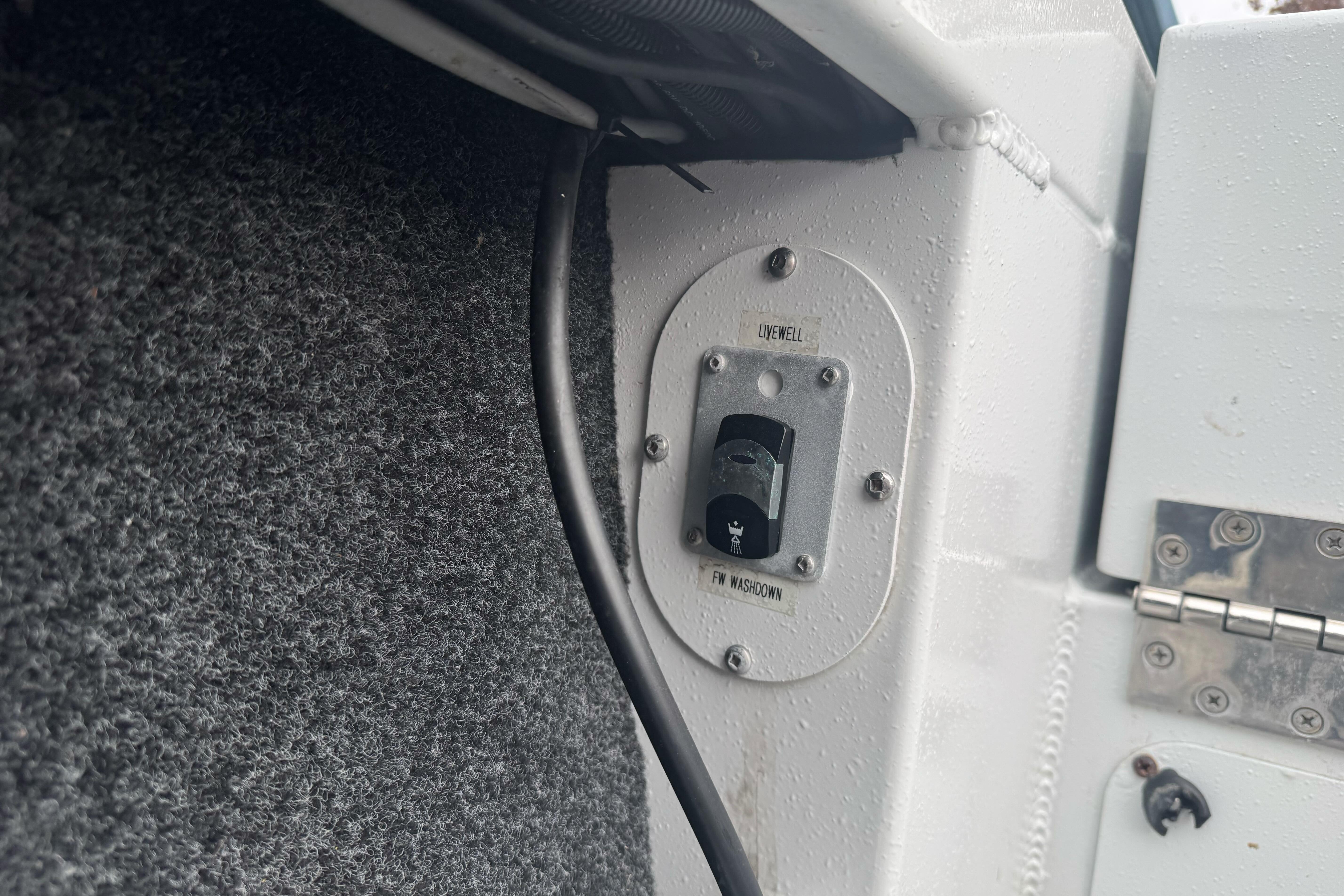 Switch panel on KingFisher 2025 Escape HHT boat, featuring livewell and washdown controls.