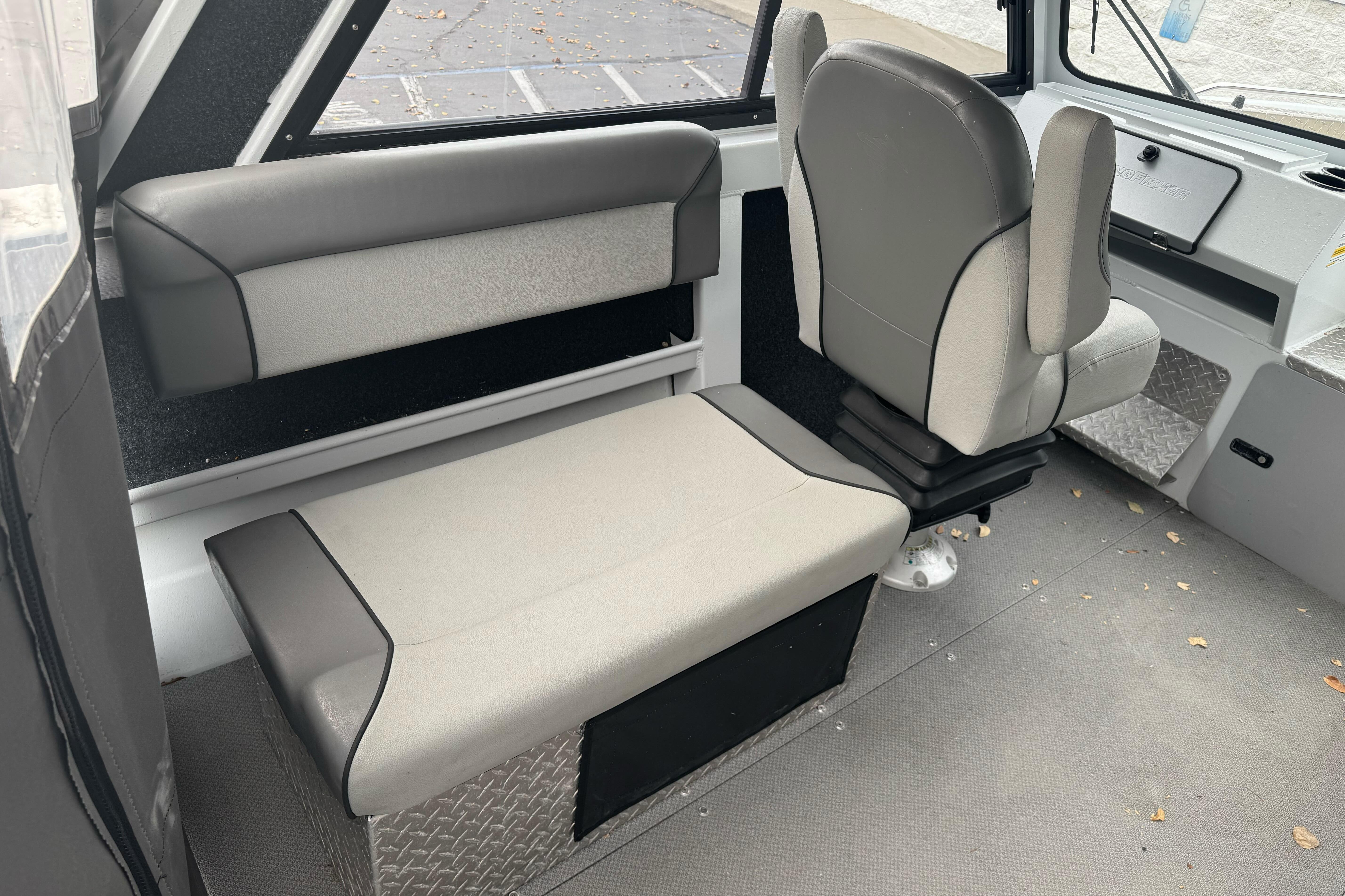 Interior of 2021 KingFisher 2025 Escape HHT boat with gray seating and modern design.