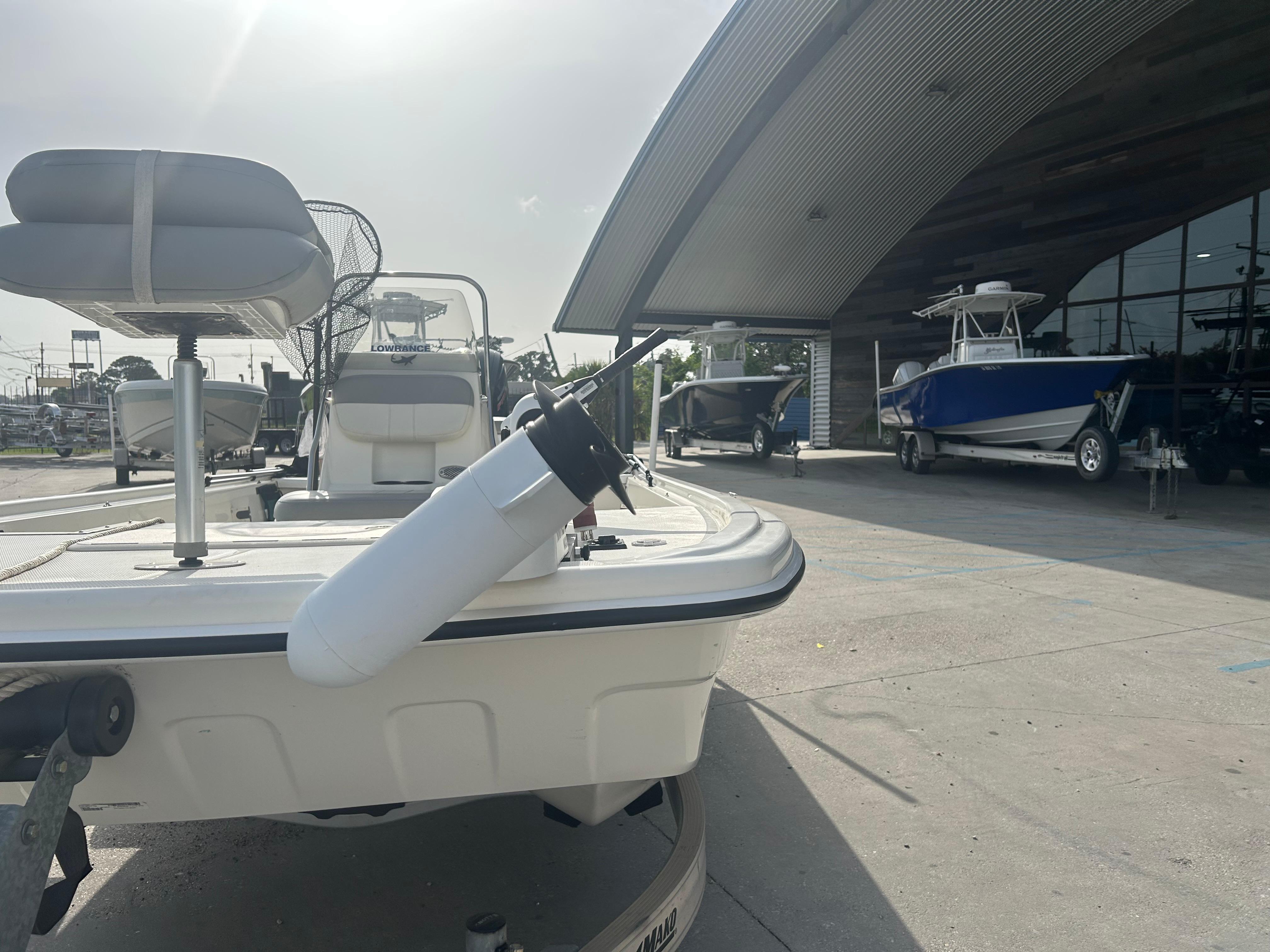 2021 Mako Pro Skiff 19 CC boat displayed at a dealership with other boats.