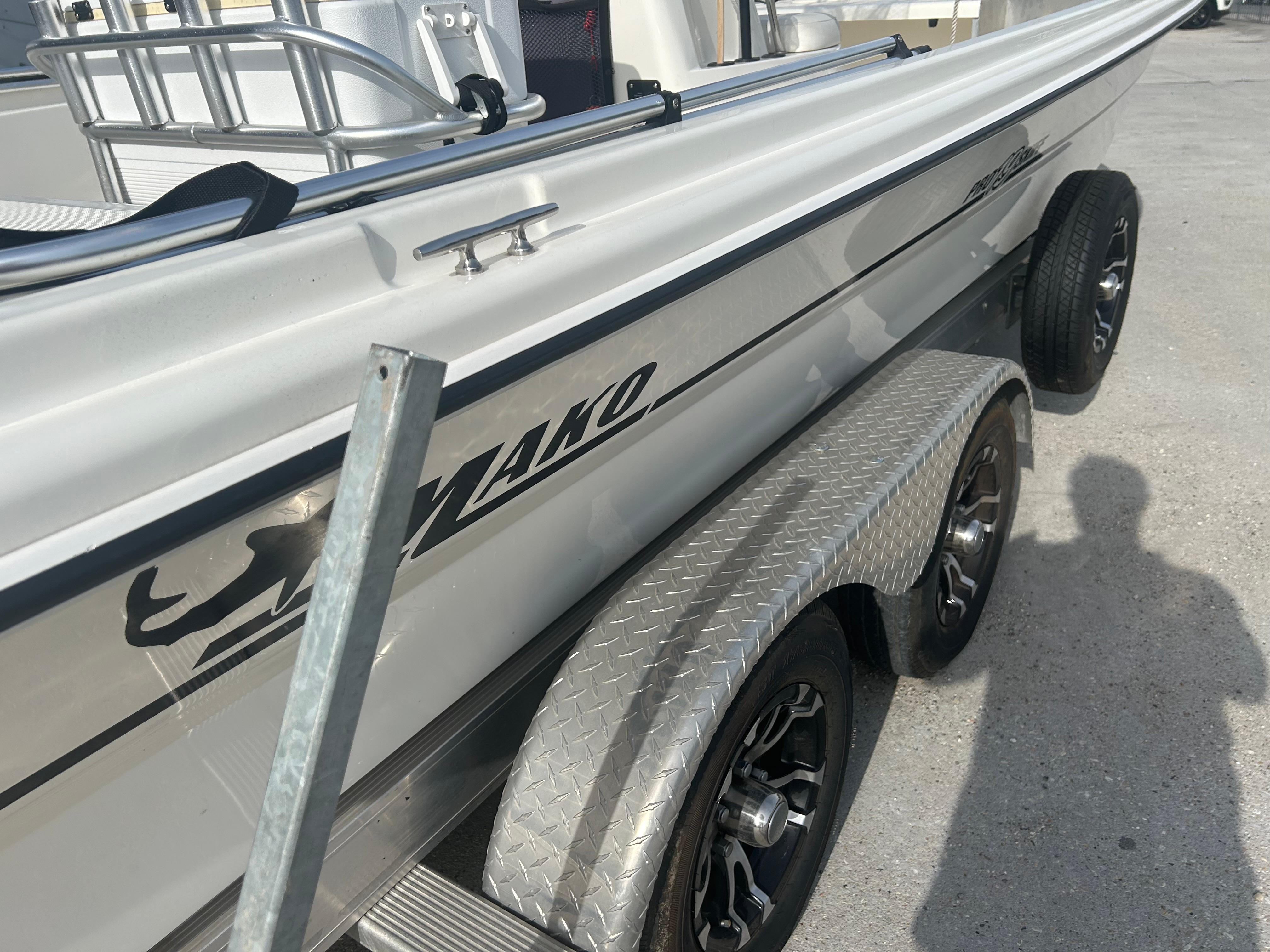 2021 Mako Pro Skiff 19 CC boat on trailer, side view with logo visible.