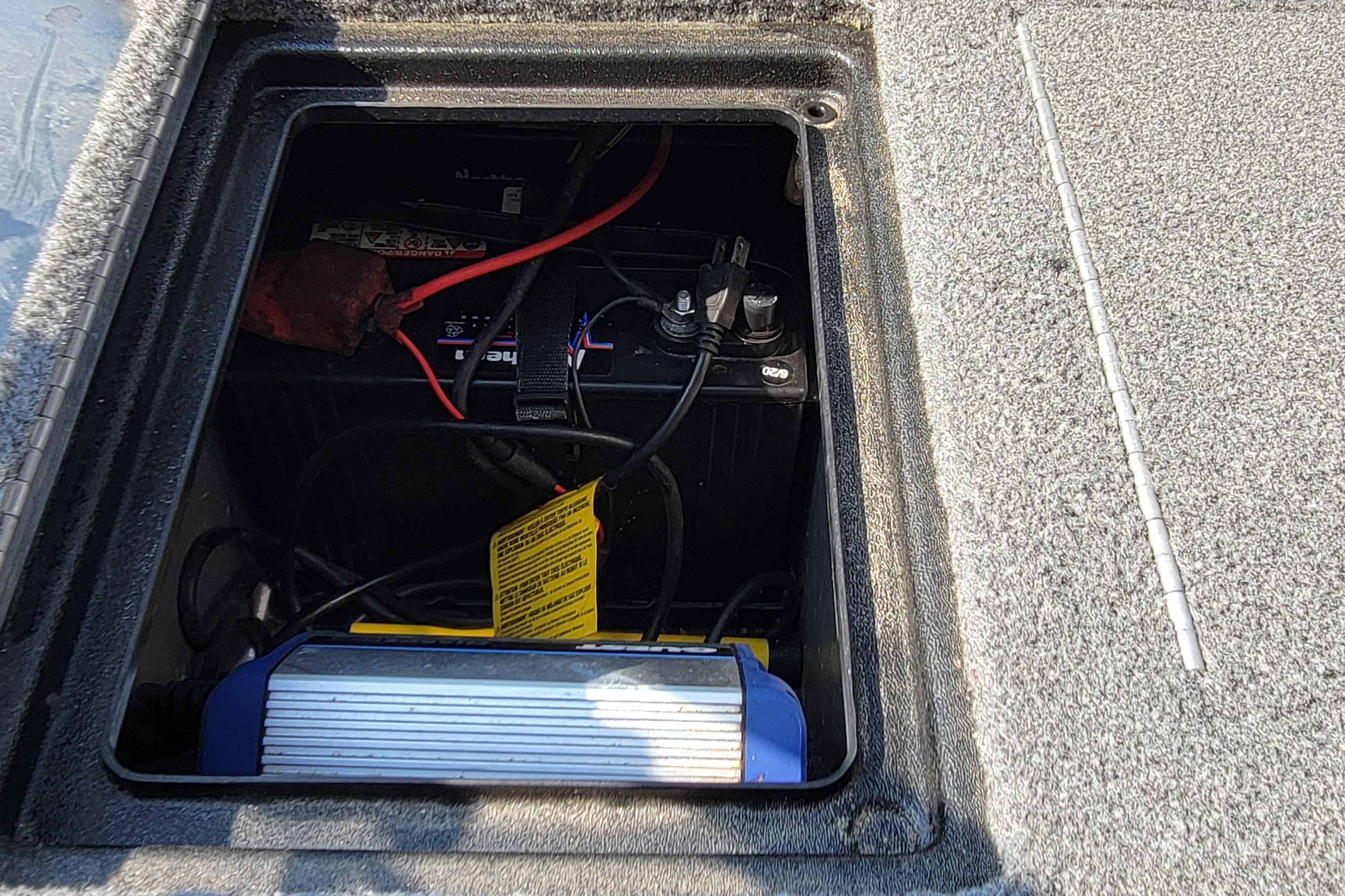 Battery compartment of 2016 TRACKER MARINE PRO GUIDE V-16 SC boat, showing wiring and connections.