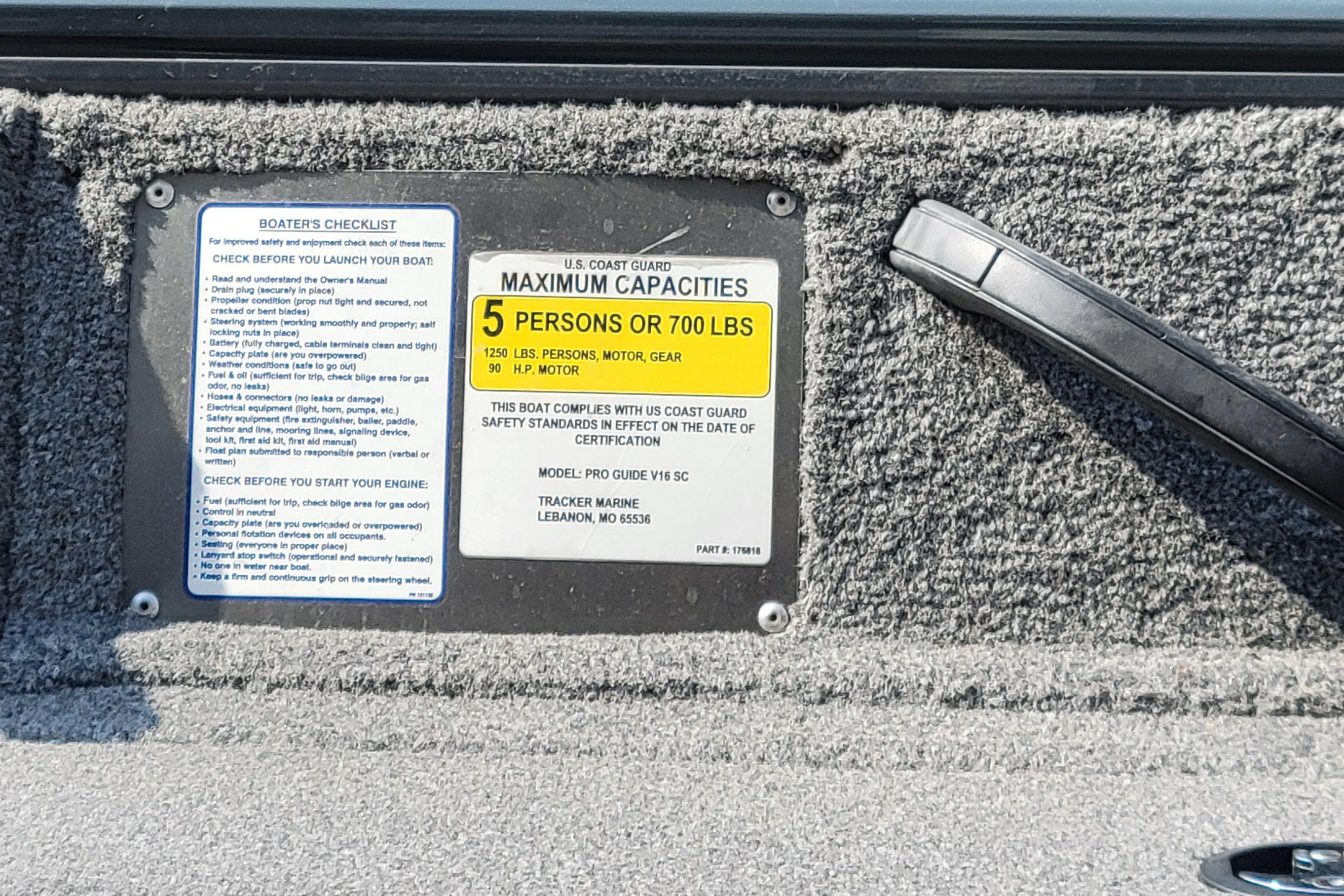 Boat capacity and safety checklist label on 2016 Tracker model, maximum 5 persons or 700 lbs.