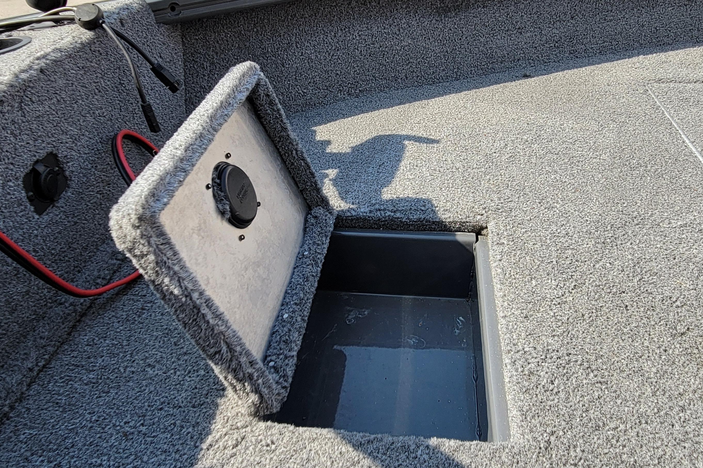 2016 Tracker boat storage compartment with open lid and visible wiring.