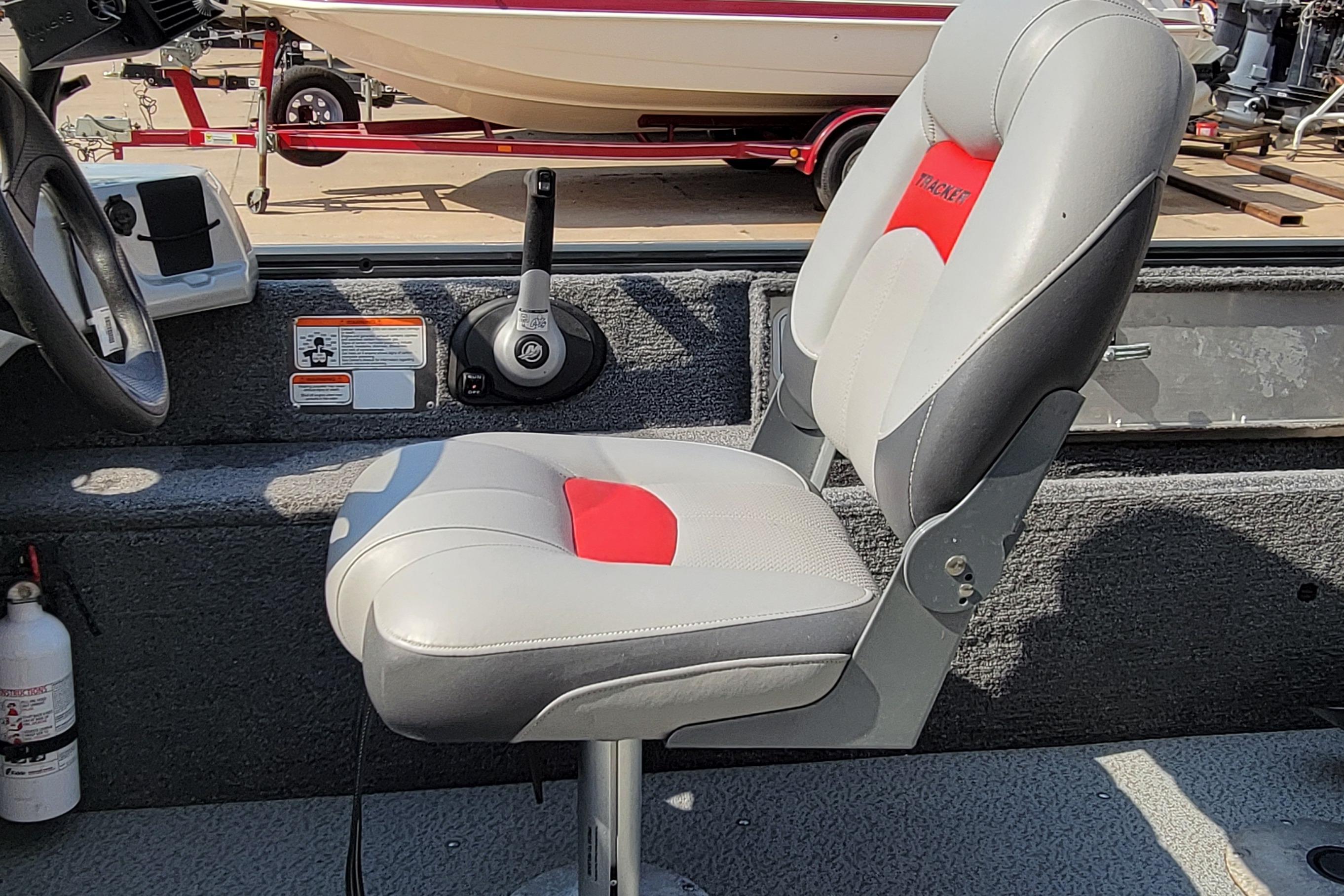 Boat interior with Tracker seat, steering wheel, and control lever, 2016 model.