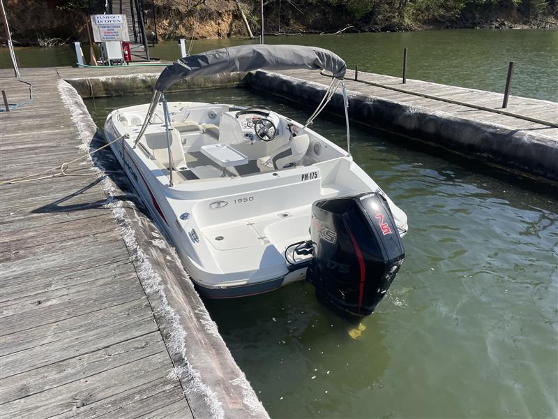 Tahoe 1950 boat docked, 2021 model, with outboard motor on a sunny day.