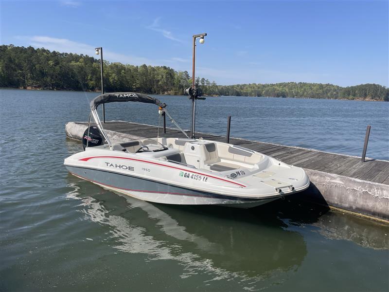 Tahoe 1950 boat docked on a serene lake, 2021 model.
