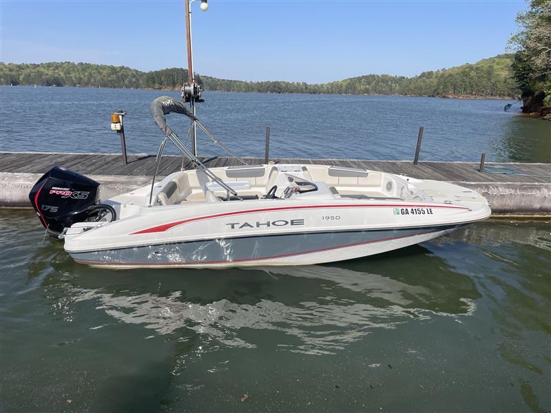 Tahoe 1950 boat docked on a serene lake, 2021 model.