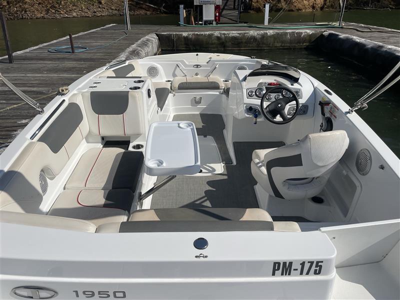 2021 Tahoe 1950 boat interior with seating and steering wheel at dock.