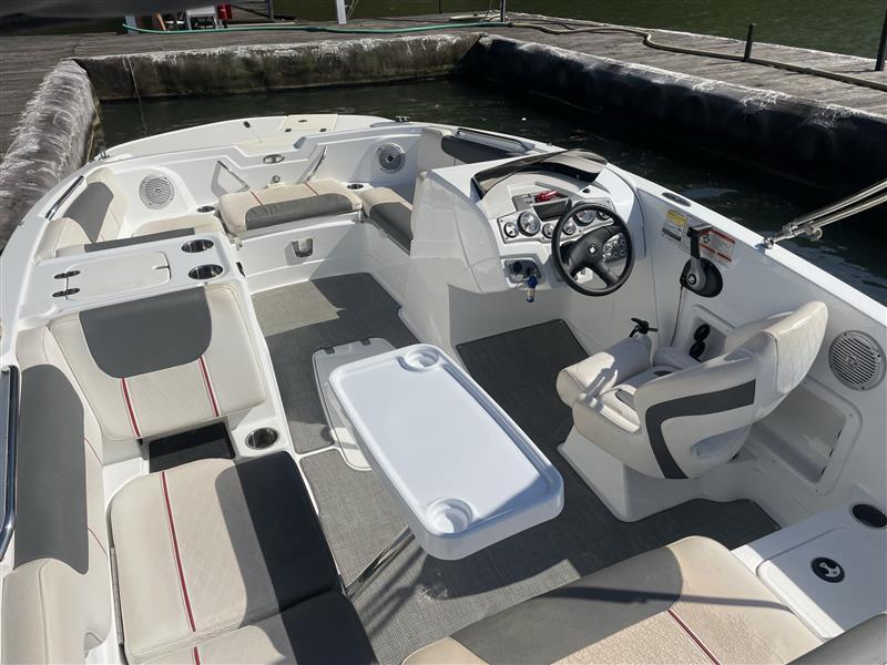 Interior of a 2021 Tahoe 1950 boat with seating and steering wheel.