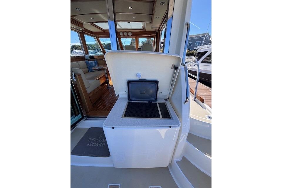 2012 Sabre 42 Salon Express yacht with open outdoor grill and luxurious interior.