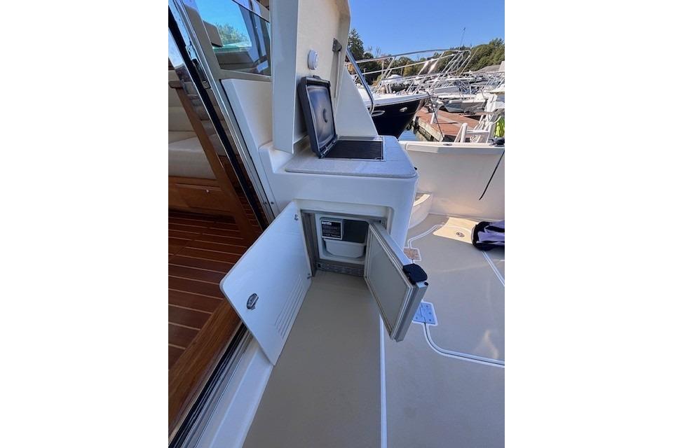 2012 Sabre 42 Salon Express yacht interior with open storage compartment and laptop.