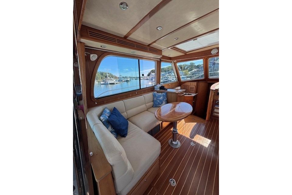 Interior of 2012 Sabre 42 Salon Express yacht with elegant wood finish and scenic window view.