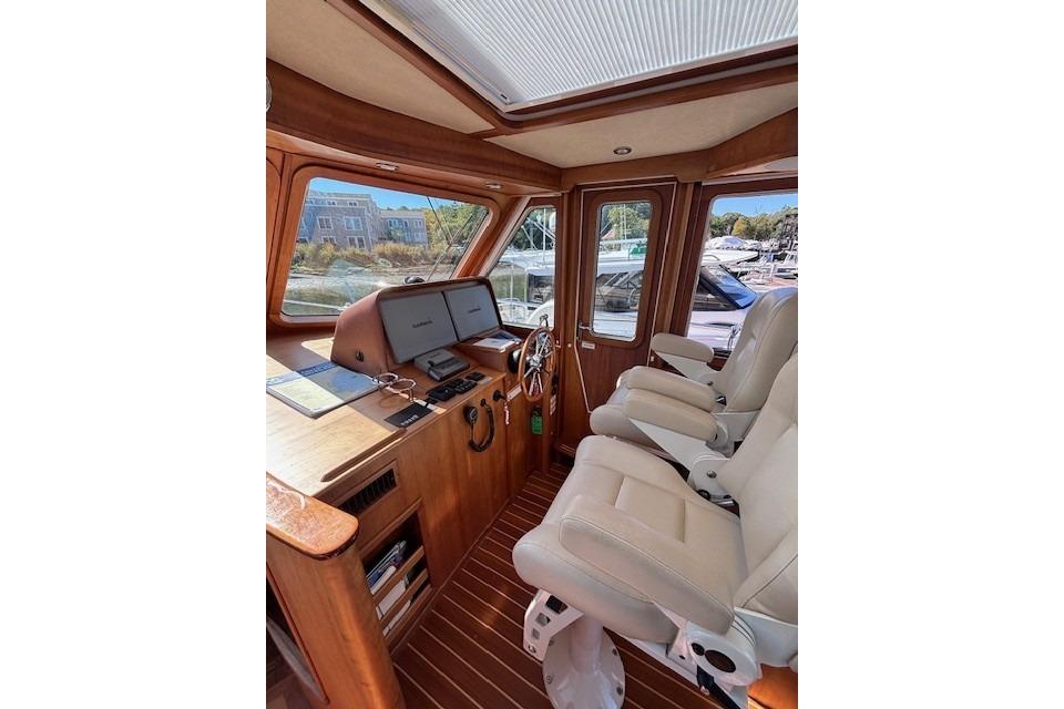 Interior of 2012 Sabre 42 Salon Express yacht with helm and seating area.