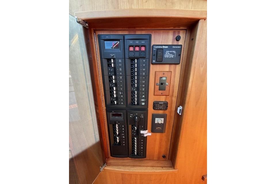 Electrical panel inside 2012 Sabre 42 Salon Express yacht, featuring circuit breakers and controls.