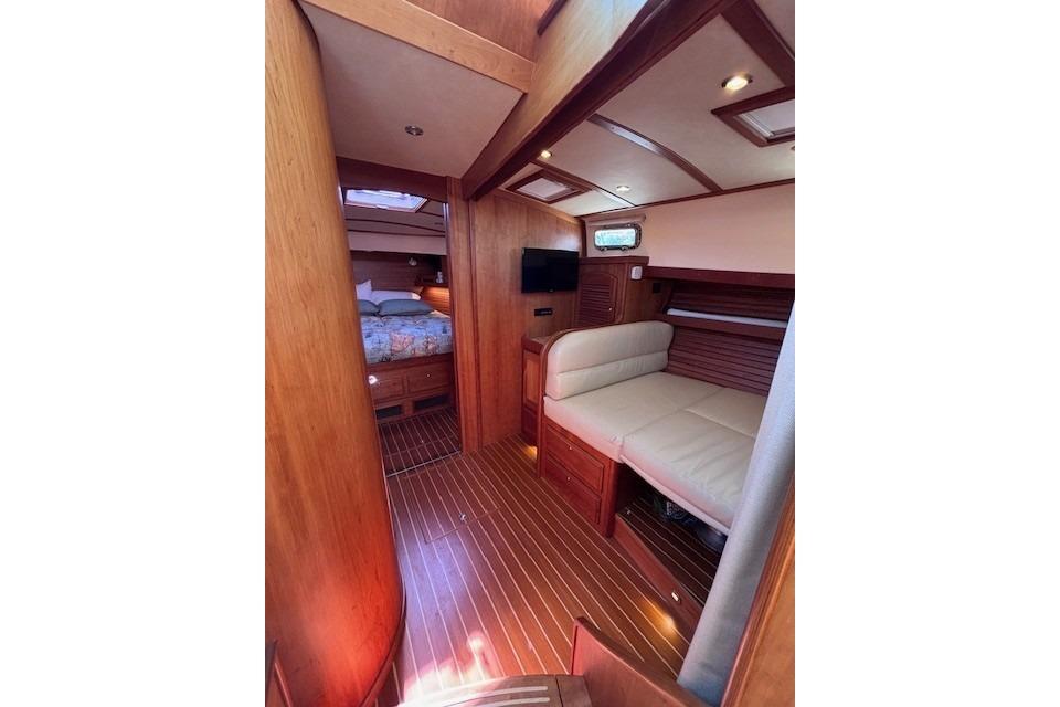 Interior of 2012 Sabre 42 Salon Express yacht, featuring cozy seating and wood finishes.