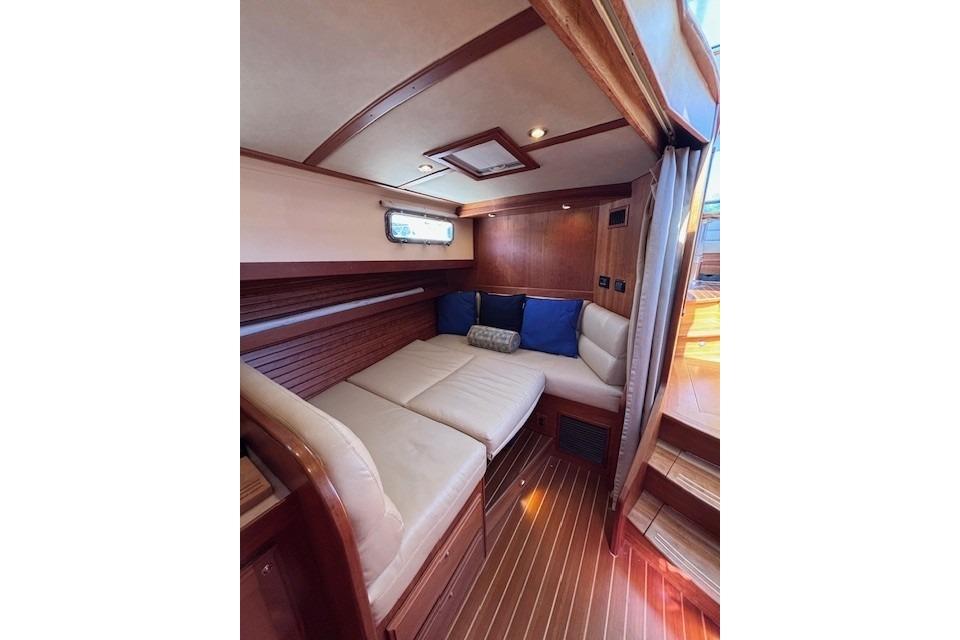 Luxurious interior of 2012 Sabre 42 Salon Express yacht with cozy seating and wooden accents.