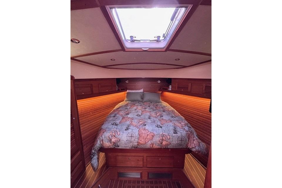 Luxurious cabin interior of 2012 Sabre 42 Salon Express with skylight and cozy bedding.