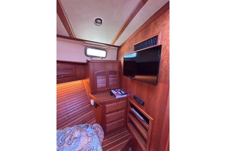 Interior of 2012 Sabre 42 Salon Express with wood paneling and mounted TV.