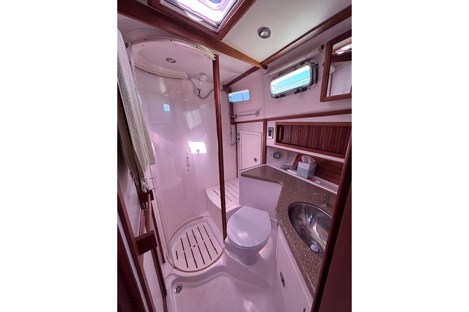 Luxurious bathroom in 2012 Sabre 42 Salon Express yacht with shower and sink.
