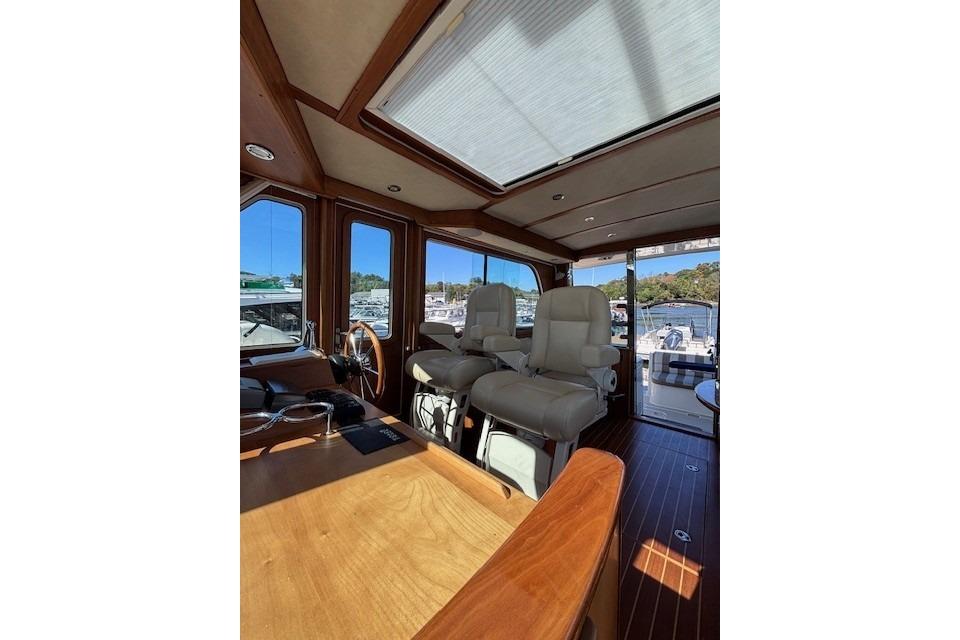 Interior of 2012 Sabre 42 Salon Express yacht with luxurious seating and wooden finishes.