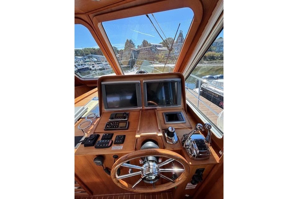 Helm of 2012 Sabre 42 Salon Express with dual screens and controls.