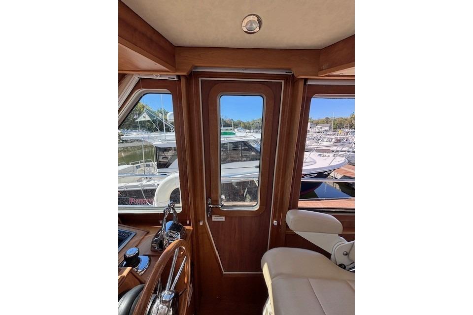 Interior view of 2012 Sabre 42 Salon Express yacht with marina background.
