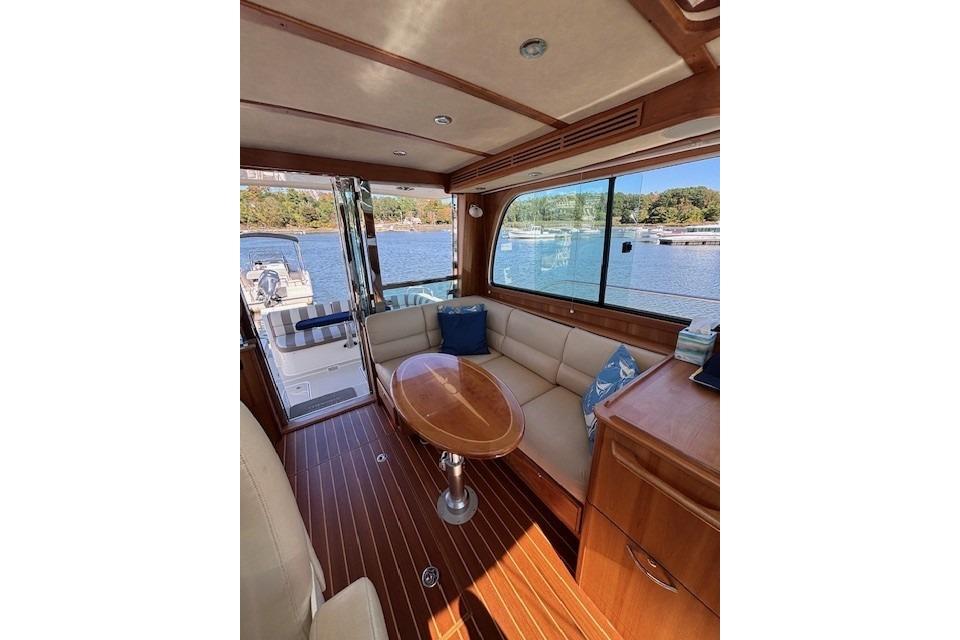 Interior of 2012 Sabre 42 Salon Express yacht with elegant wood finish and waterfront view.