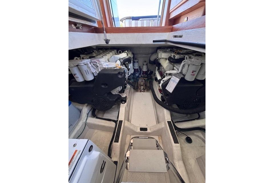 Engine room of 2012 Sabre 42 Salon Express, showcasing dual engines and mechanical components.