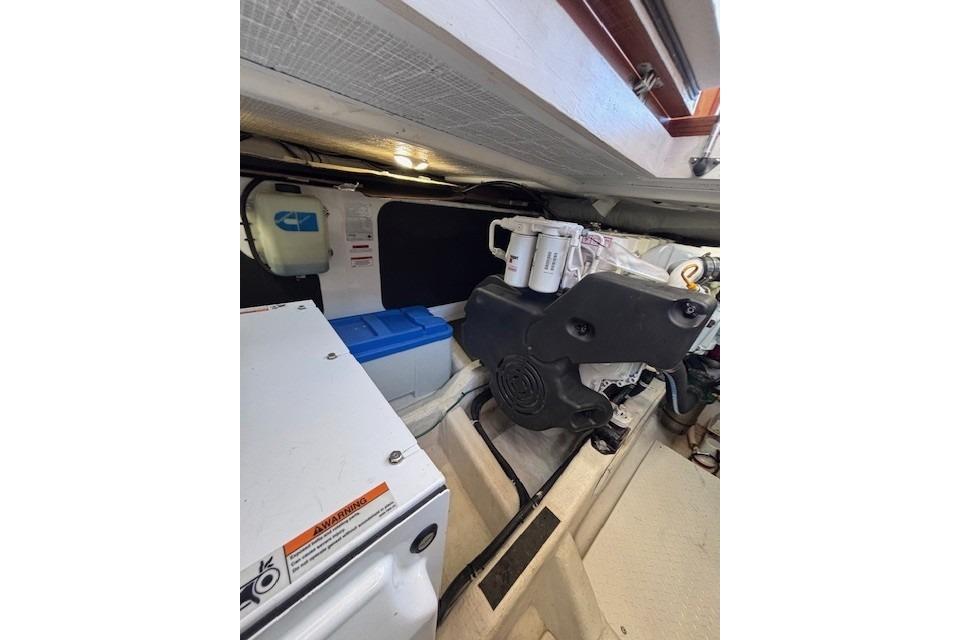 Engine room of 2012 Sabre 42 Salon Express, showcasing mechanical components and storage.
