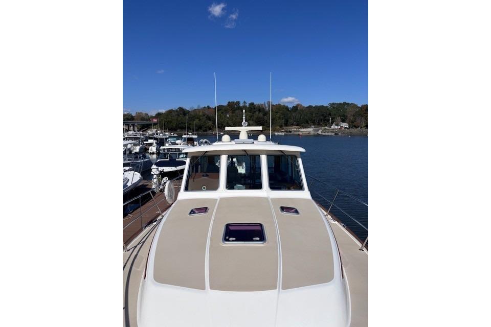 2012 Sabre 42 Salon Express yacht on calm water, clear sky background.