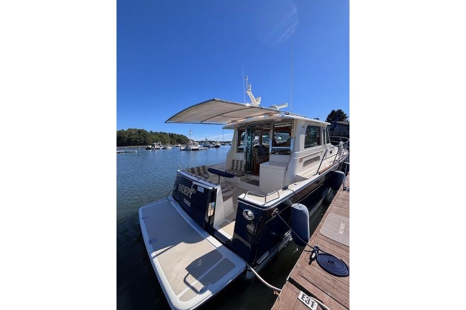 2012 Sabre 42 Salon Express yacht docked in a serene marina setting.