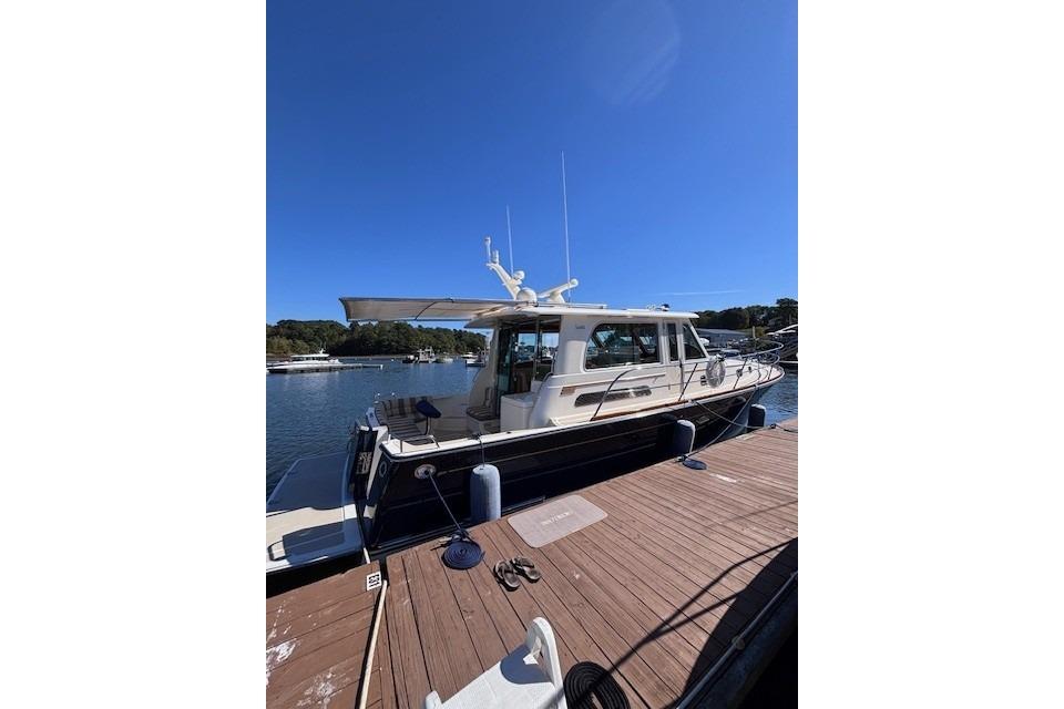 2012 Sabre 42 Salon Express yacht docked under clear blue sky.