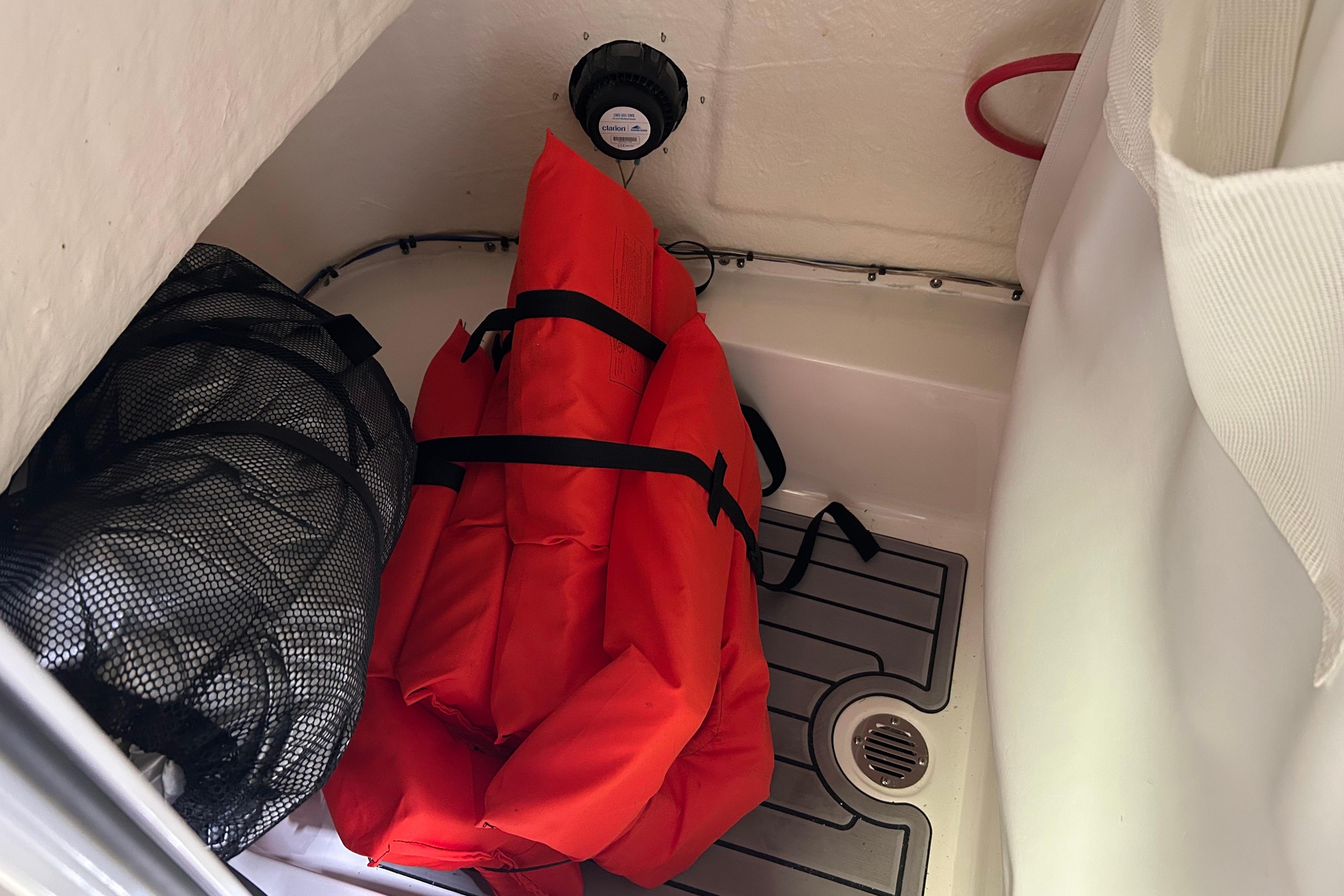 Storage compartment in 2024 Tidewater 198 CC Adventure boat with life jackets and gear.