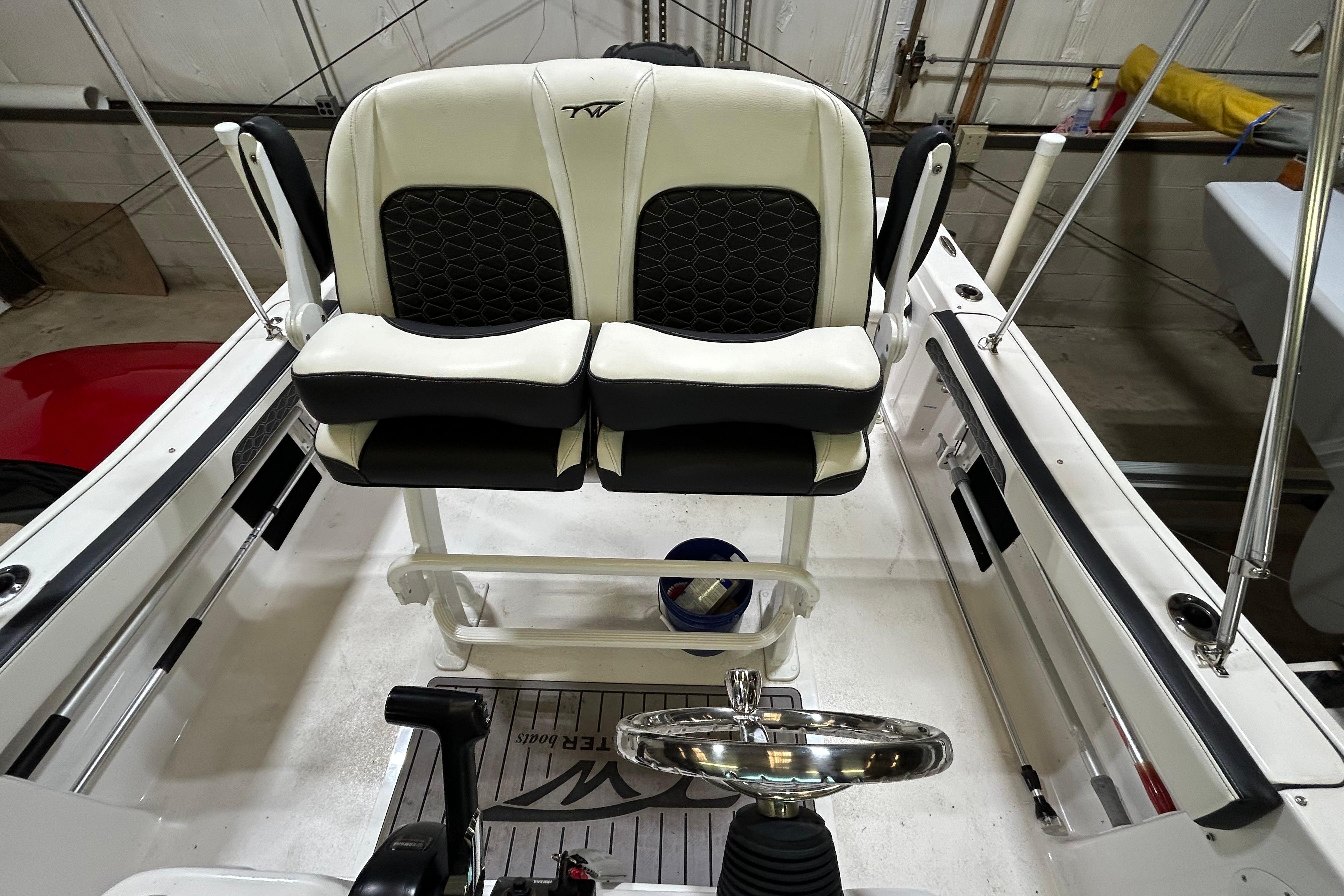 2024 Tidewater 198 CC Adventure boat interior with dual seats and steering wheel.