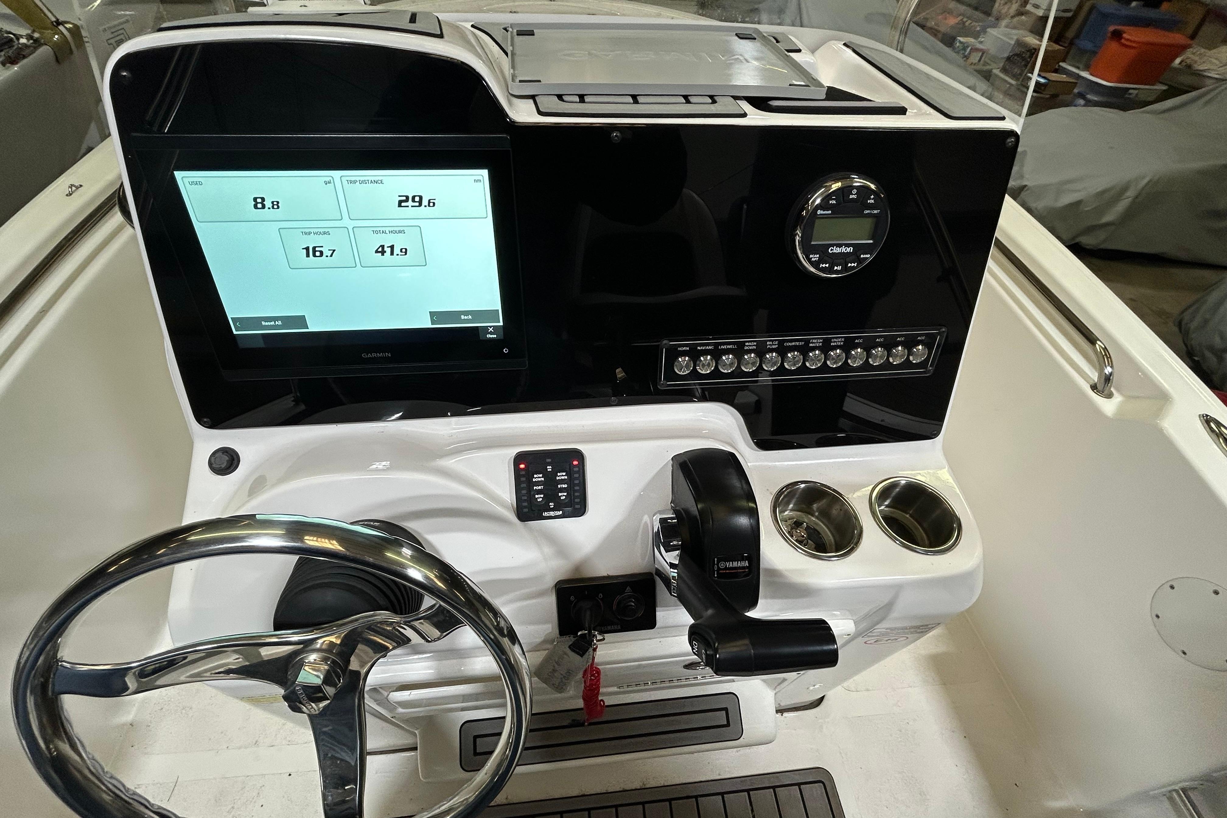2024 Tidewater 198 CC Adventure boat dashboard with steering wheel and digital display.