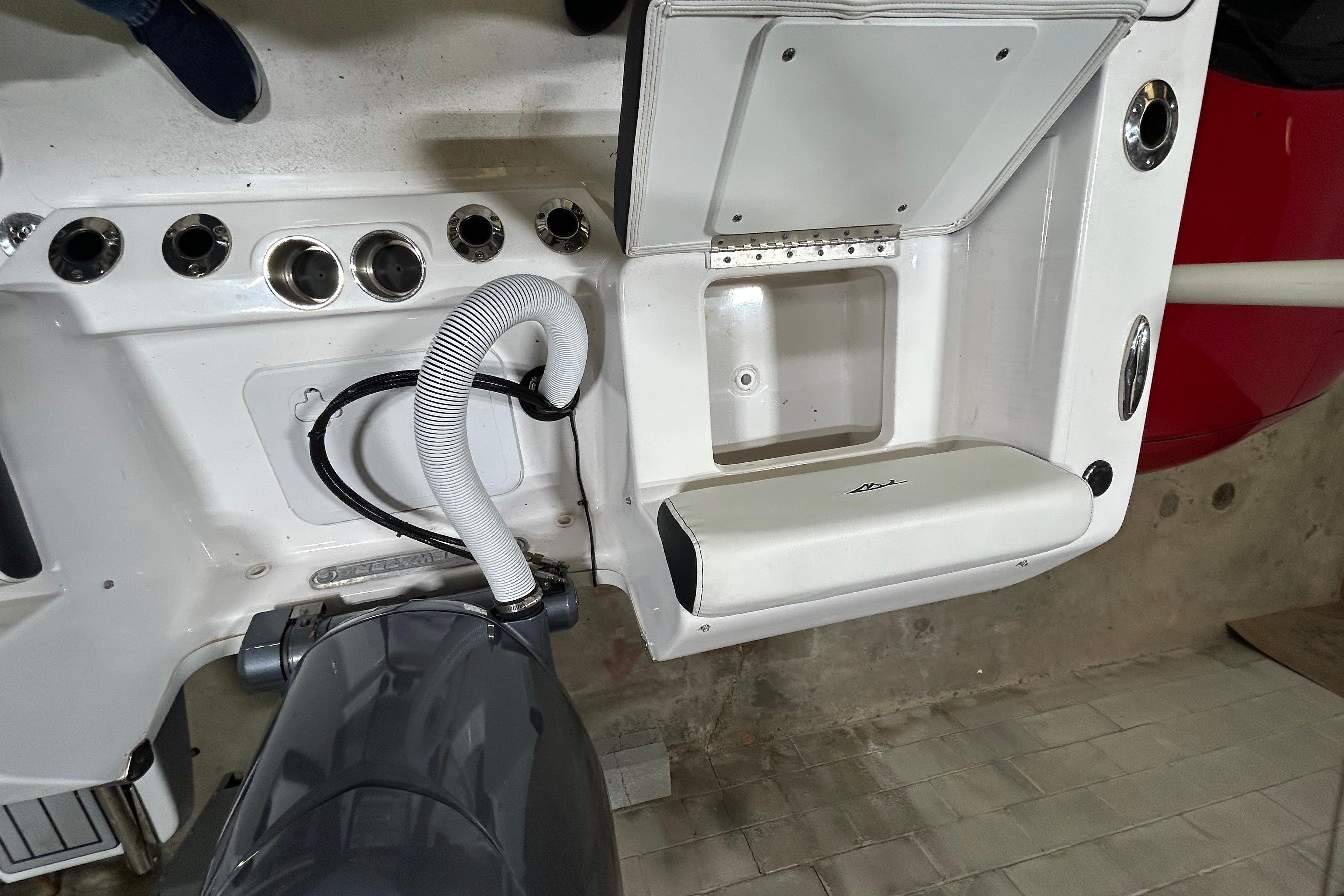 2024 Tidewater 198 CC Adventure boat interior with engine and storage compartment.