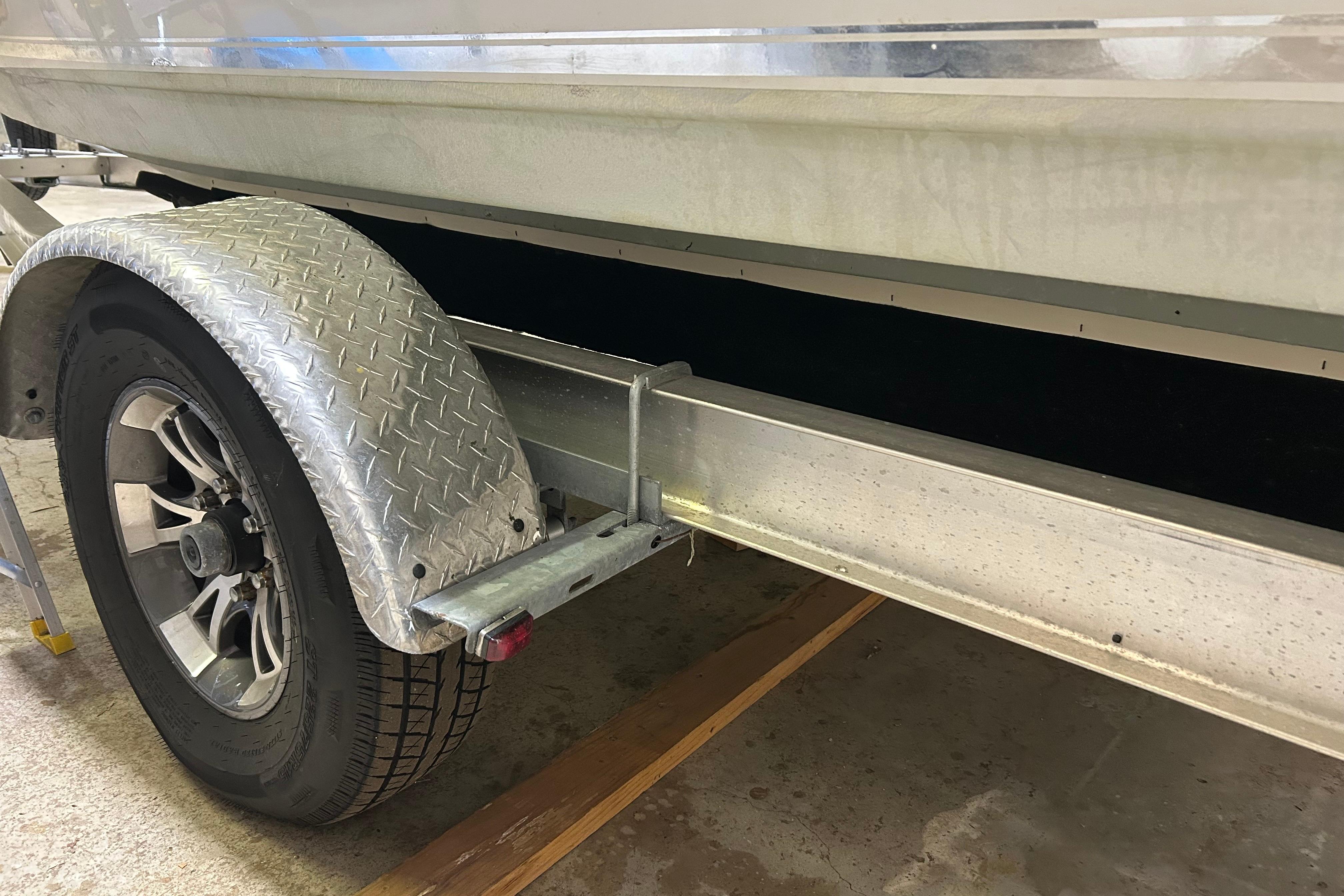 Trailer wheel and fender of 2024 Tidewater 198 CC Adventure boat.
