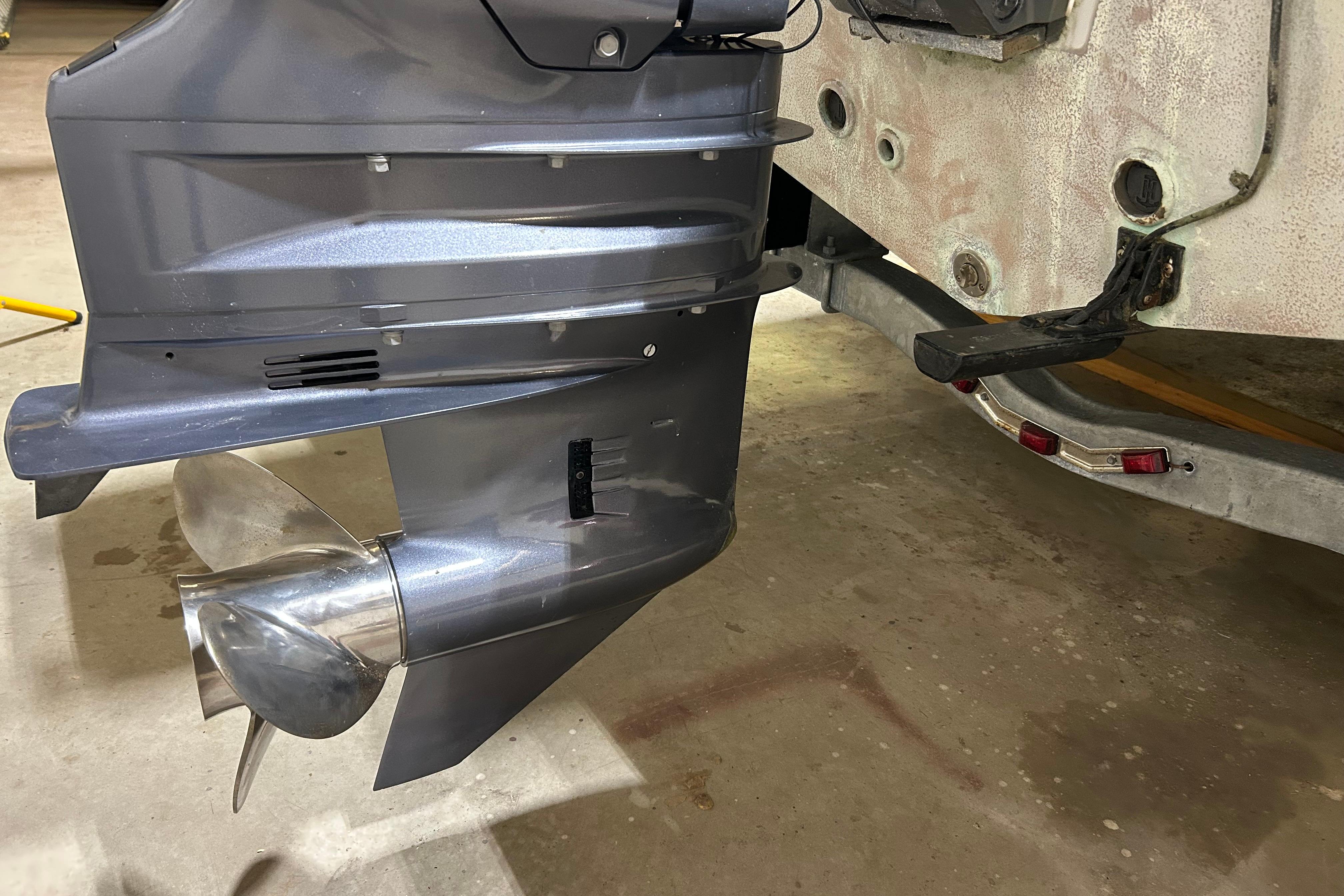 2024 Tidewater 198 CC Adventure boat propeller and motor detail in a garage setting.
