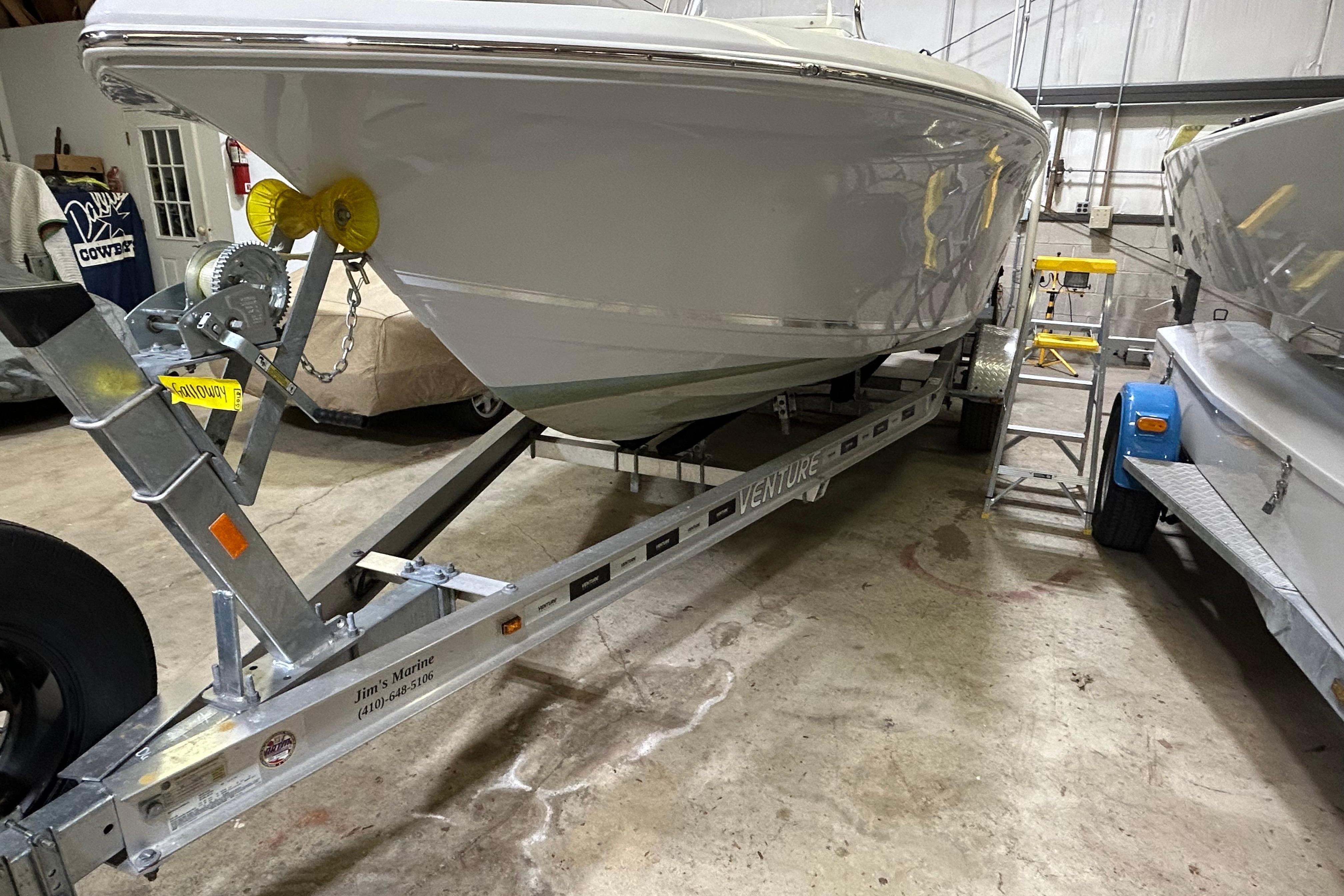 2024 Tidewater 198 CC Adventure boat on trailer in a garage setting.